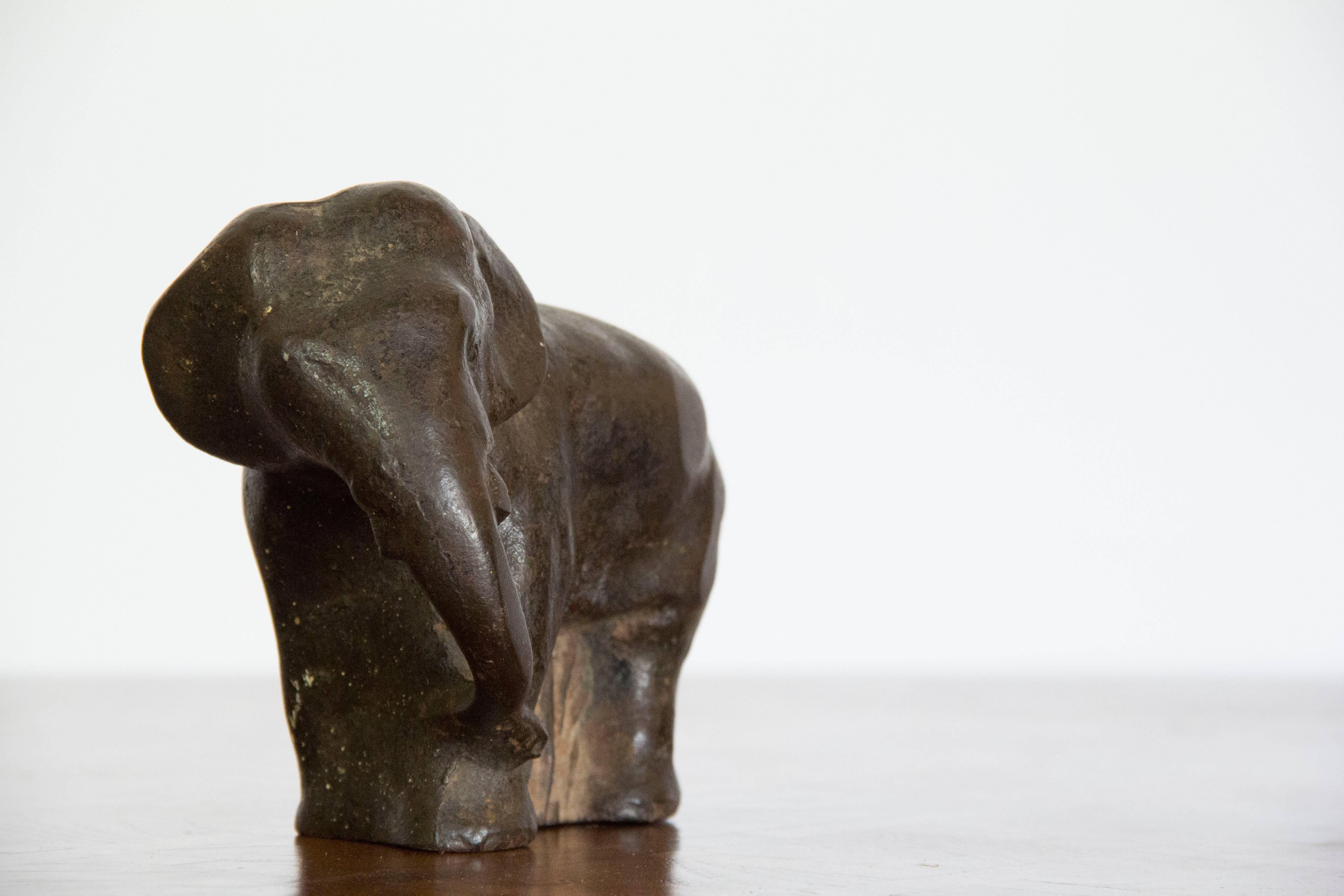 Charming cast iron elephant door stop. A substantial piece with nice weight and a great collector's item.