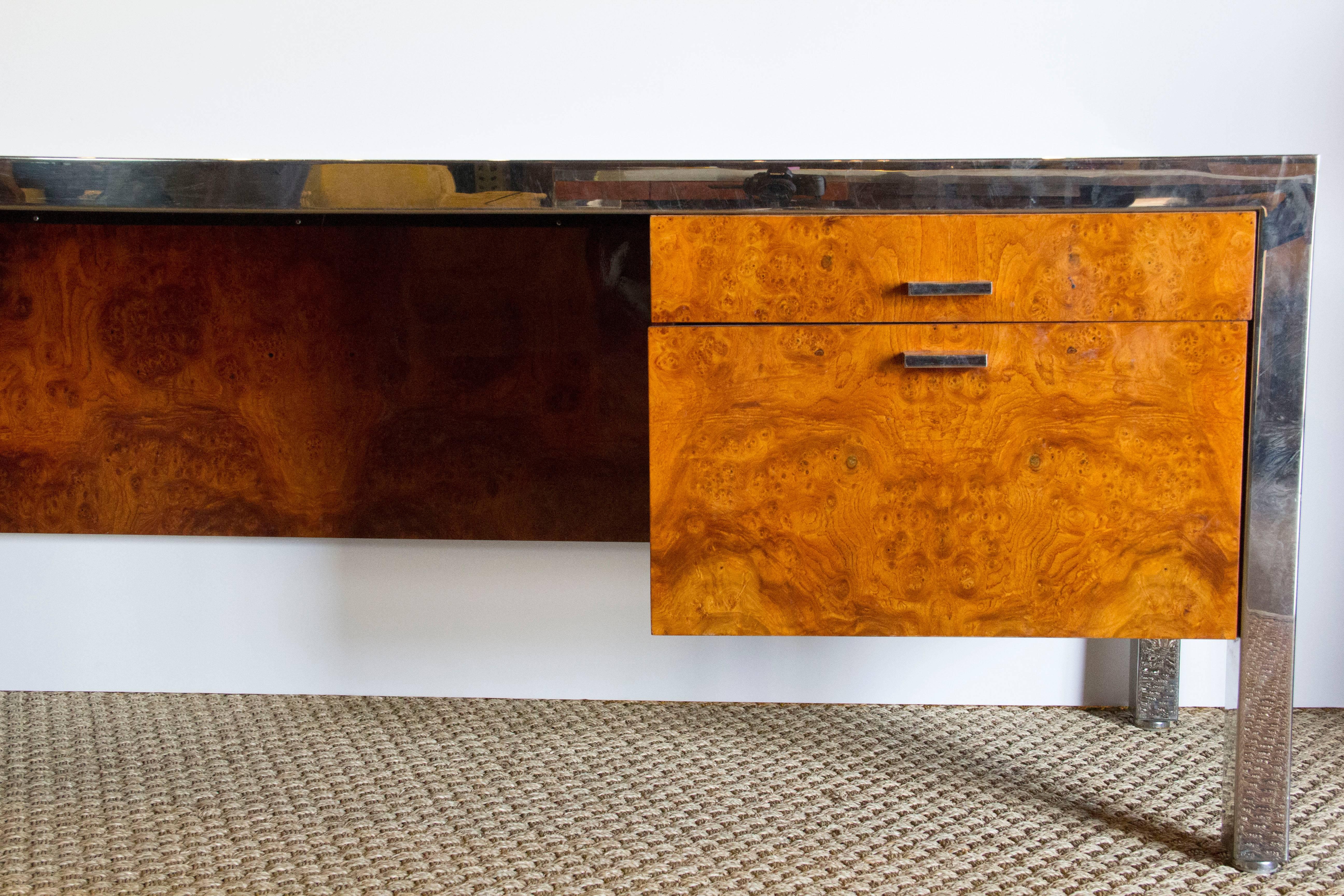 Incredible burl wood credenza with chrome legs, burl wood top and drawers. Four drawers, one shorter, one deeper, on each end.