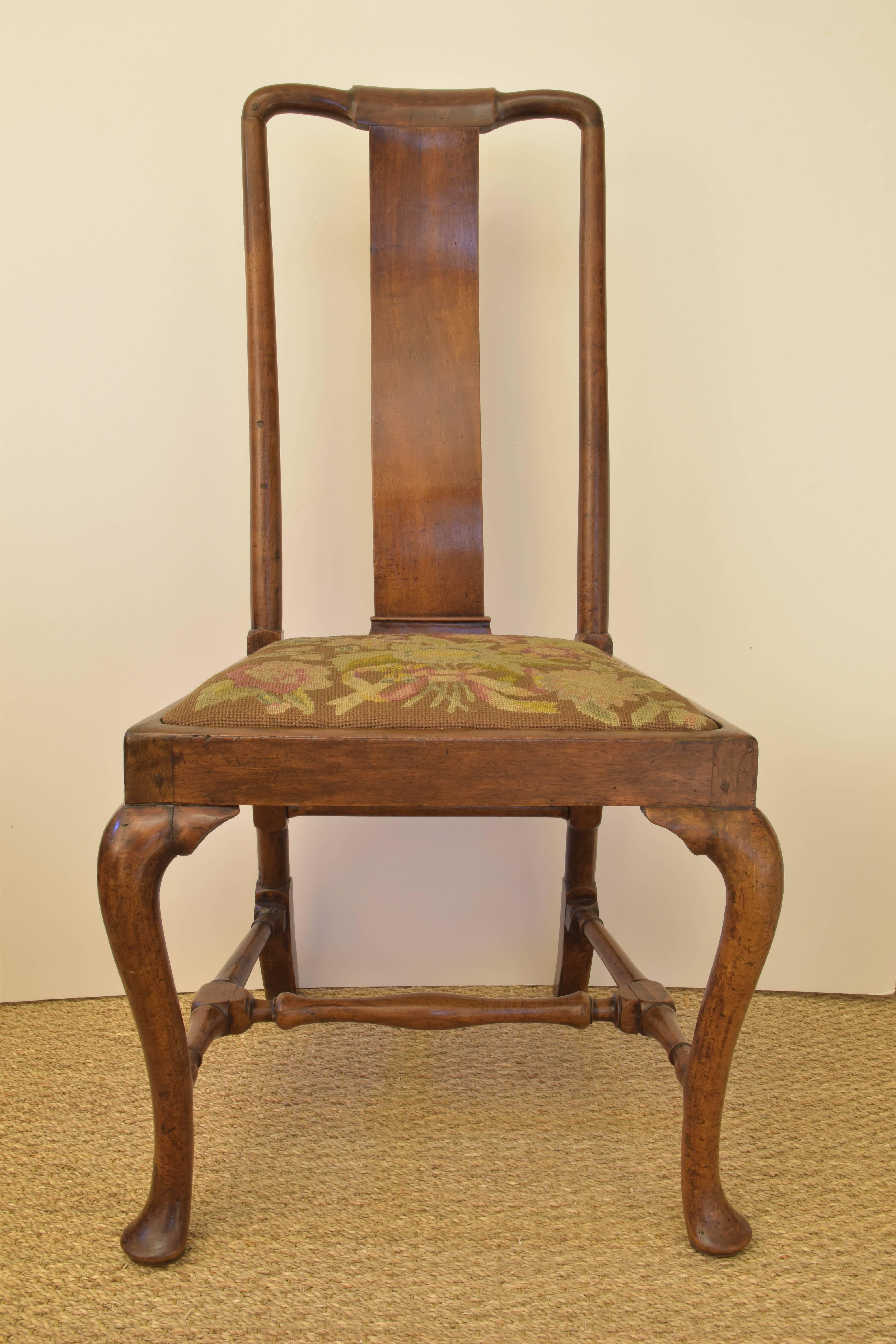 A beautifully proportioned chair with peg construction and an original needlepoint seat.