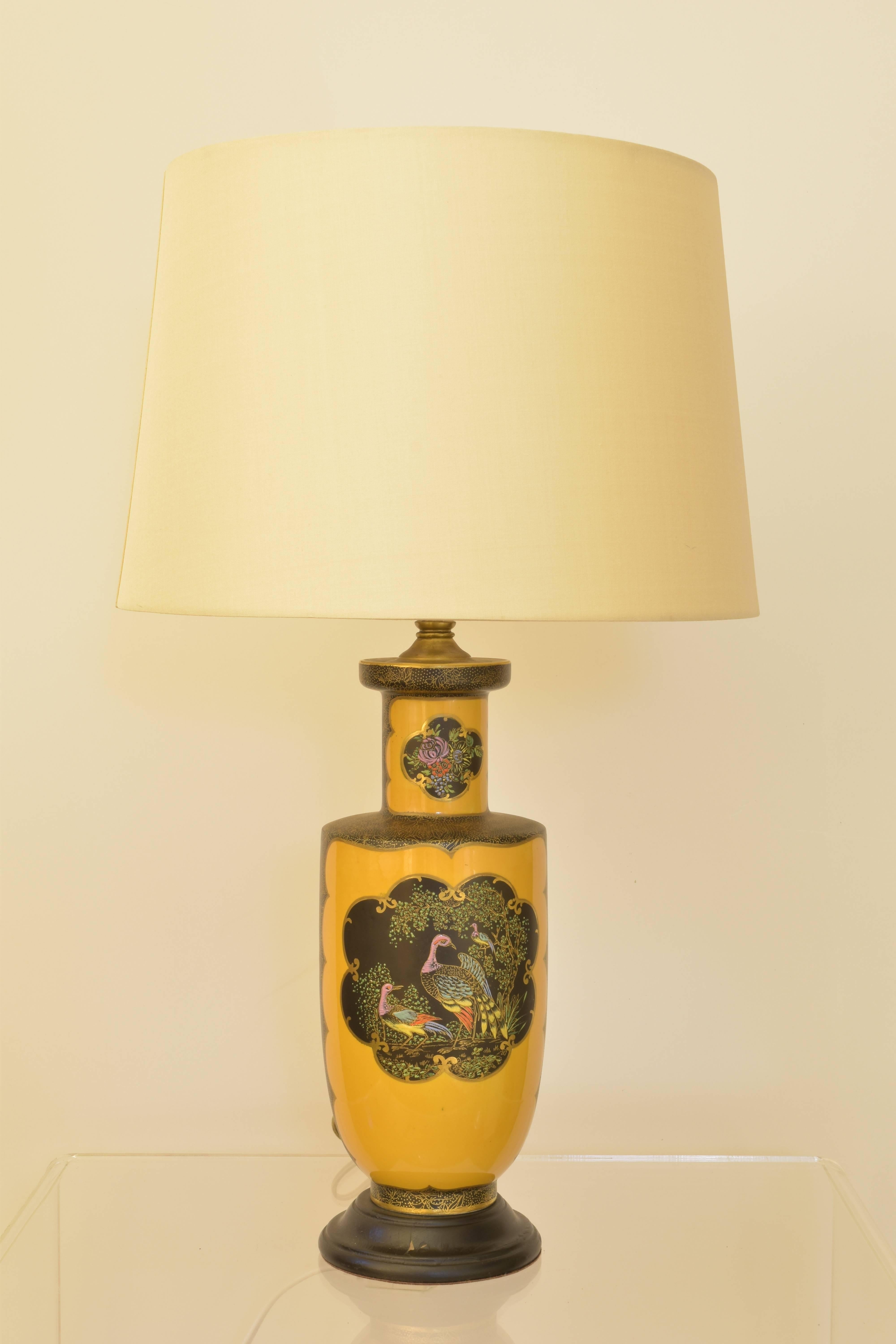 Chinese highly detailed porcelain lamp with painted birds and in a strong golden yellow coloration. 

Lamp measures 24