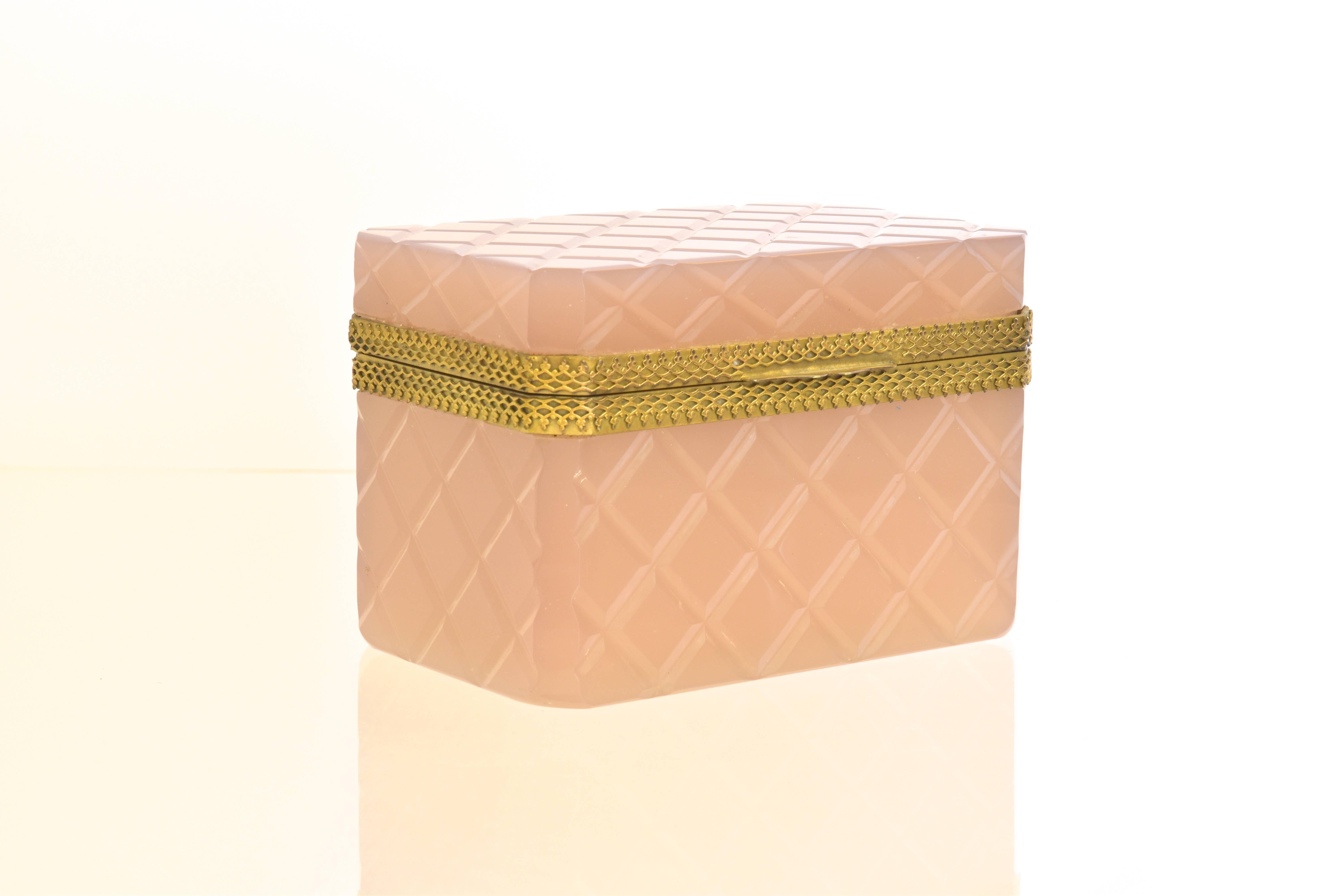 A beautifully detailed Murano trinket box with cut corners and diamond pattern throughout. The glass box is hinged and is in a soft shade of pastel pink.