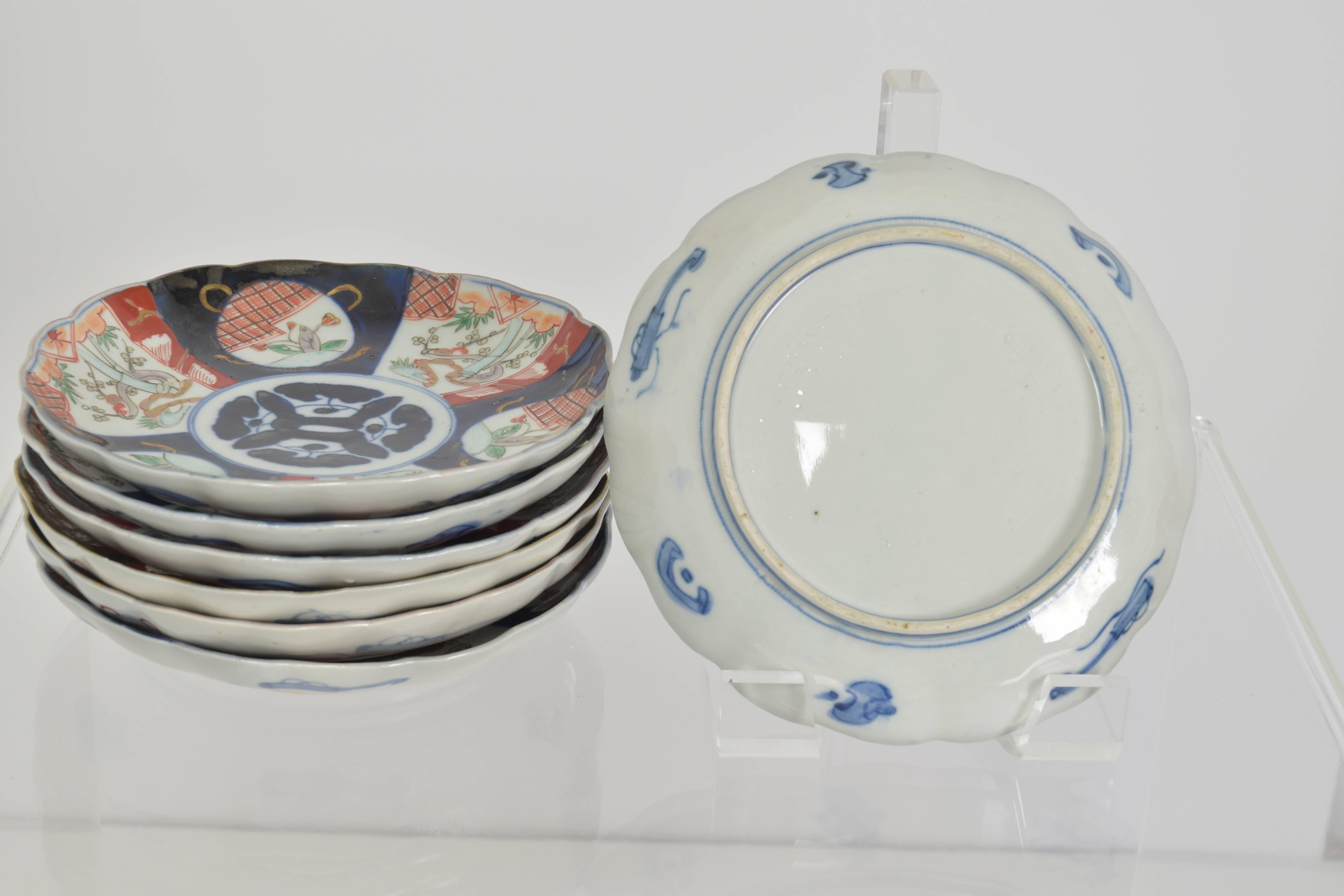 Collection of seven hand-painted Imari porcelain decorative plates.