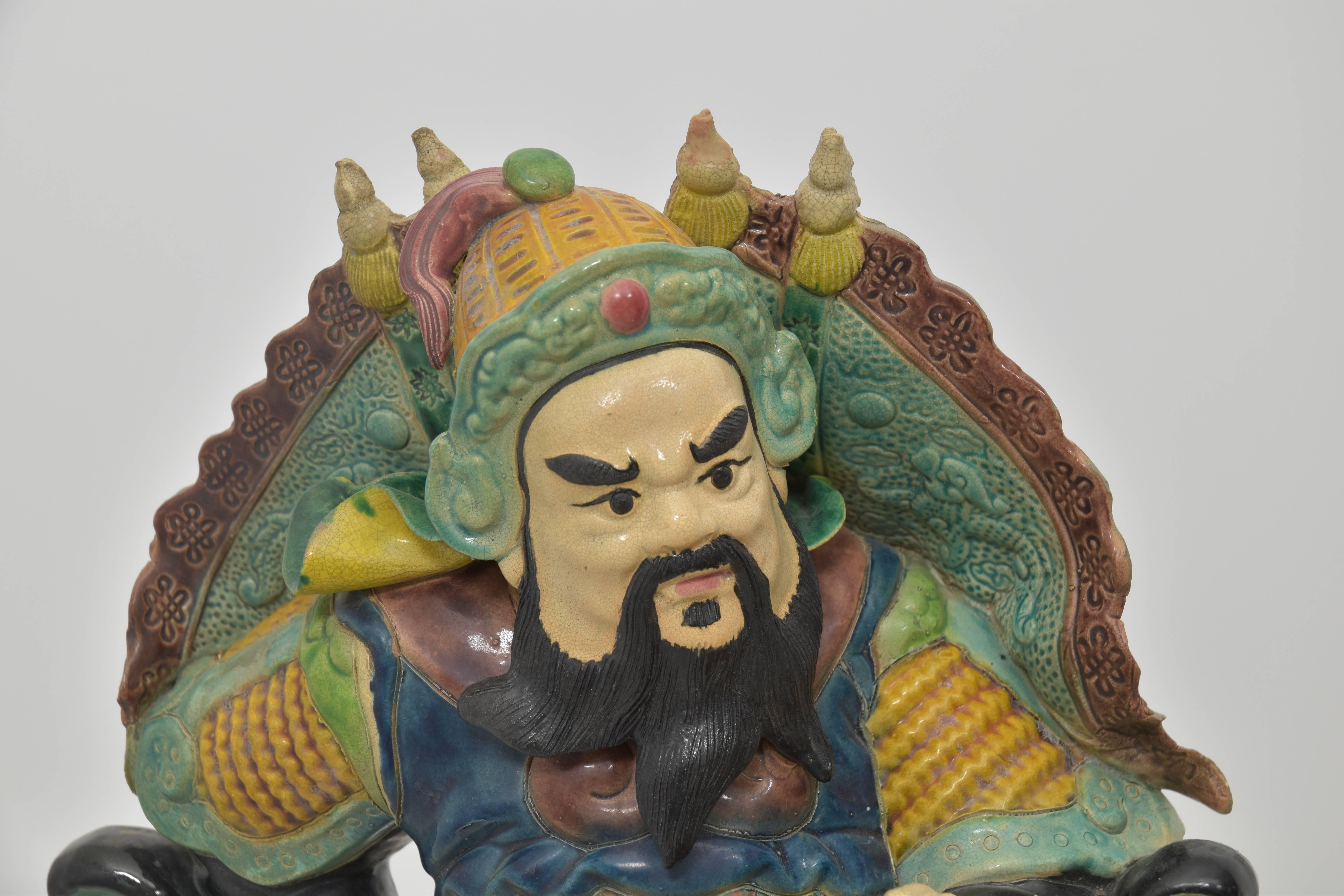 A hand formed Chinese warrior roof tile mounted to a lucite base with great coloration.