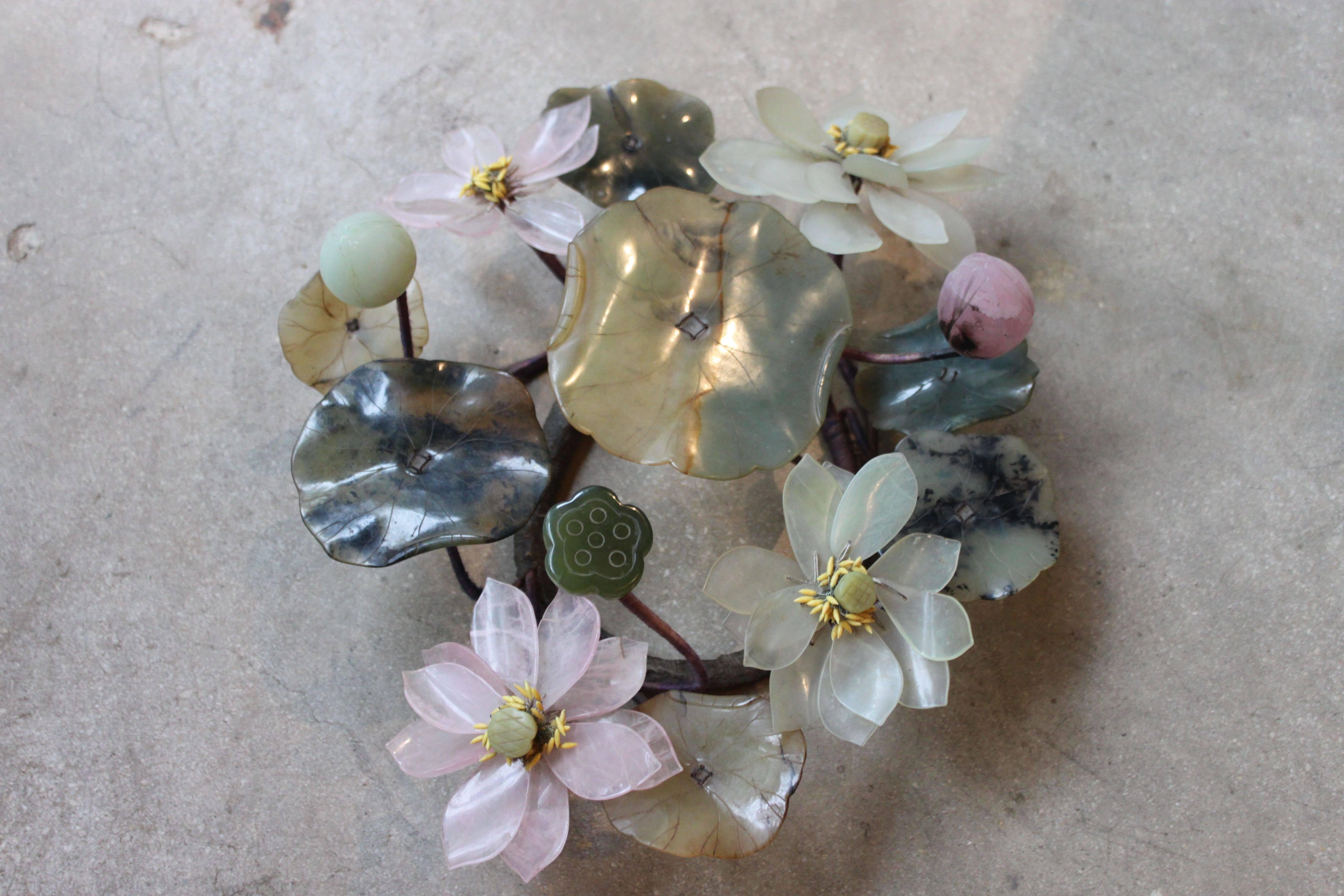 Lovely hard stone sculpture of flowers and water lilies. Also included are lotus pods and lily pads of varying shades of greens, pinks and creams. Unusually large size with a great degree of detailing.