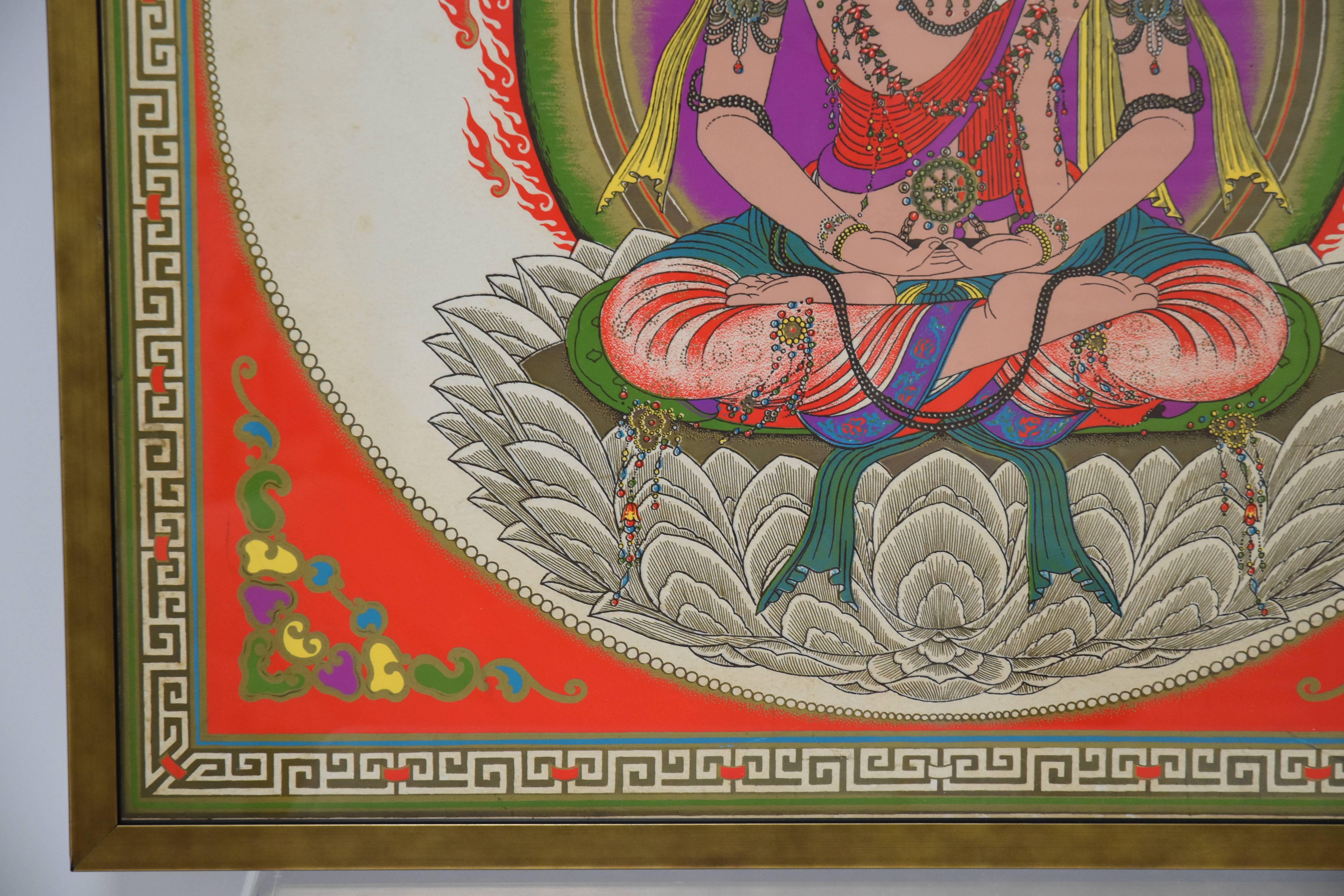 Vividly colored print of a seated Hindu diety with vibrant shades of orange, purple green and bordered with a gold Greek key detail.