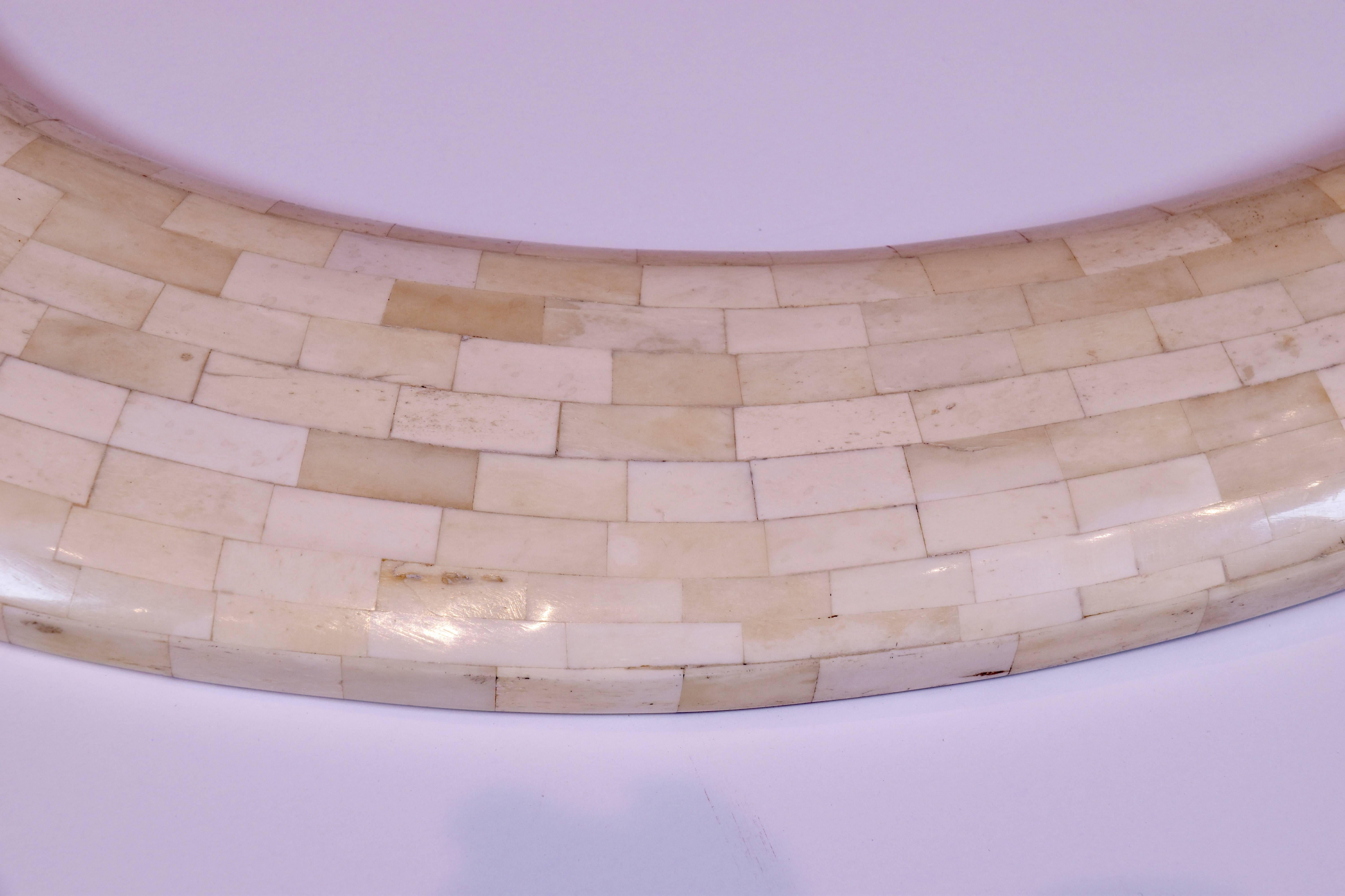 Vintage mirror with a tessellated bone frame of graduated oval form.