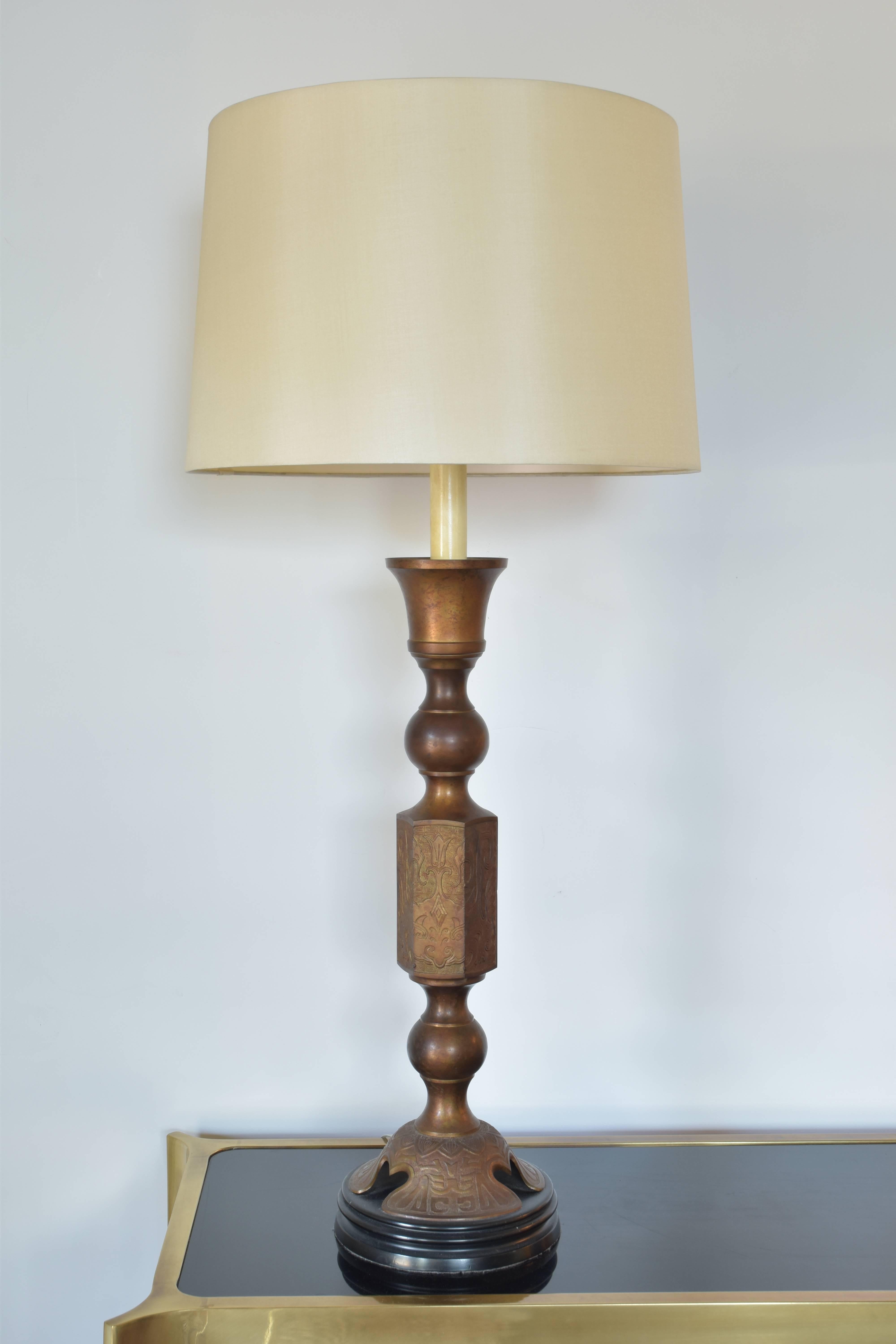 Monumental James Mont style gilded bronze lamp on original wood base.  An exceptionally large and striking lamp.