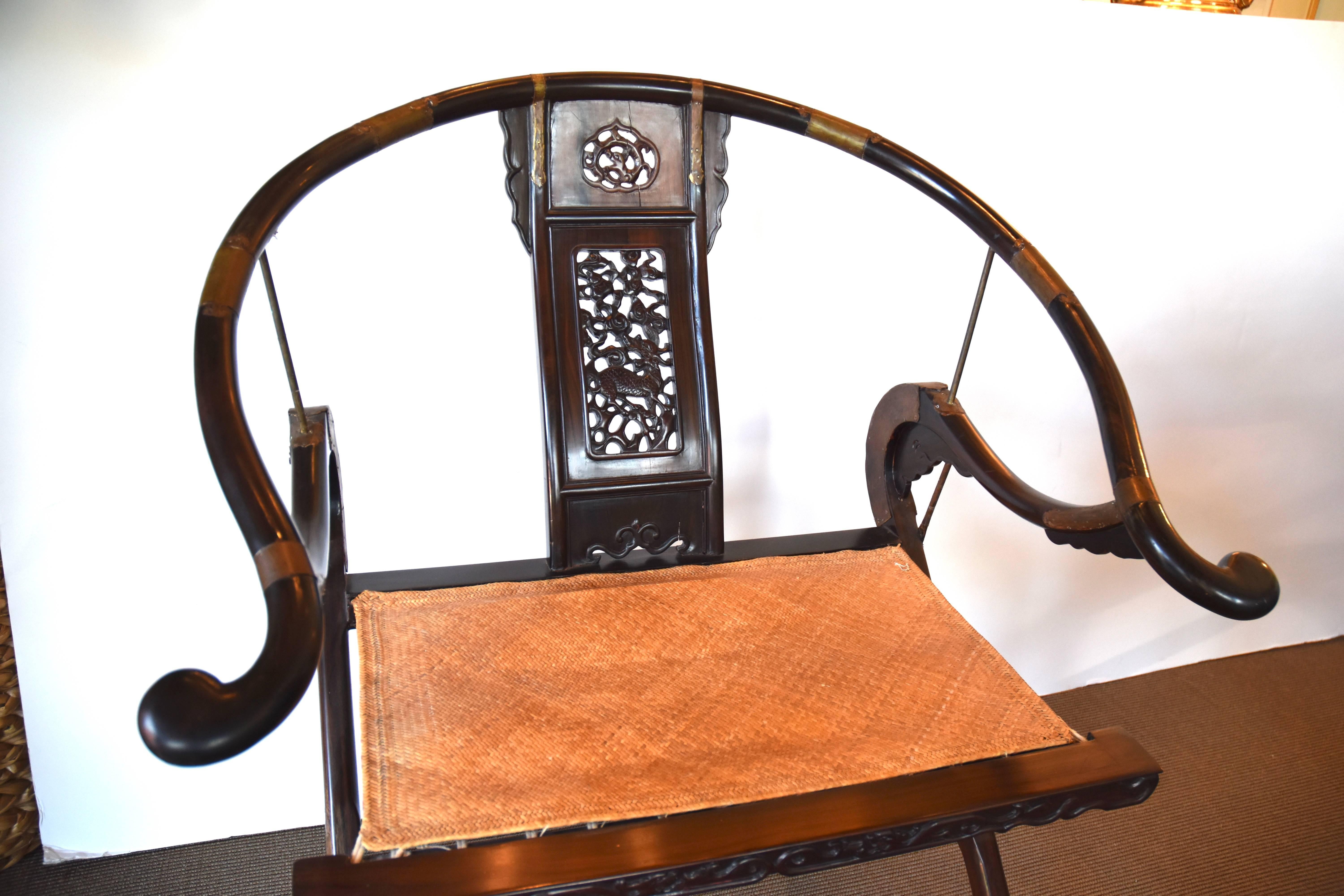 Pair of Chinese folding chairs or hunting chairs with original woven seats and brass decoration throughout. The chairs are early 20th century.