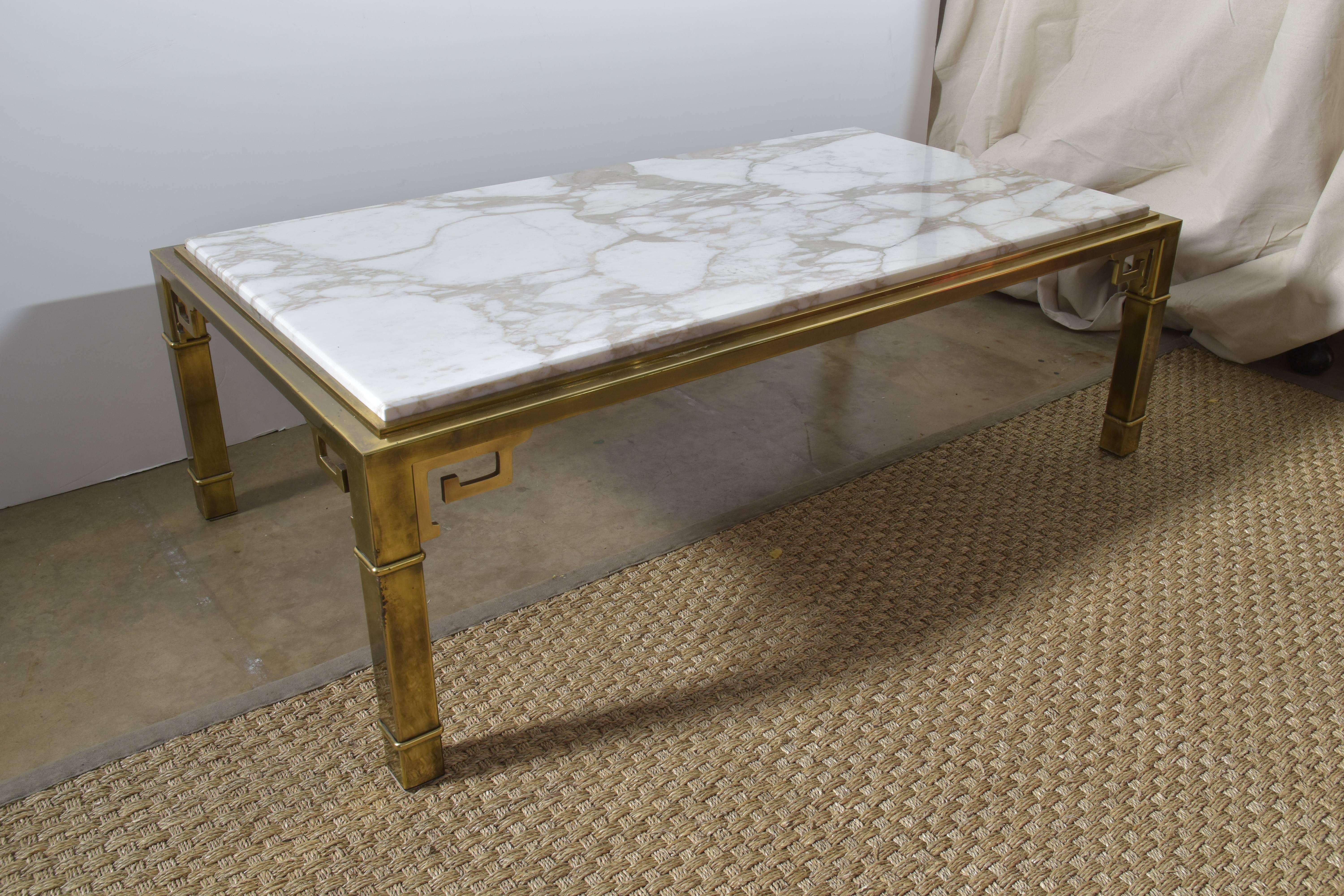 Beautiful vintage Mastercraft brass cocktail or coffee table with a Calcutta marble top and Greek key detailing.