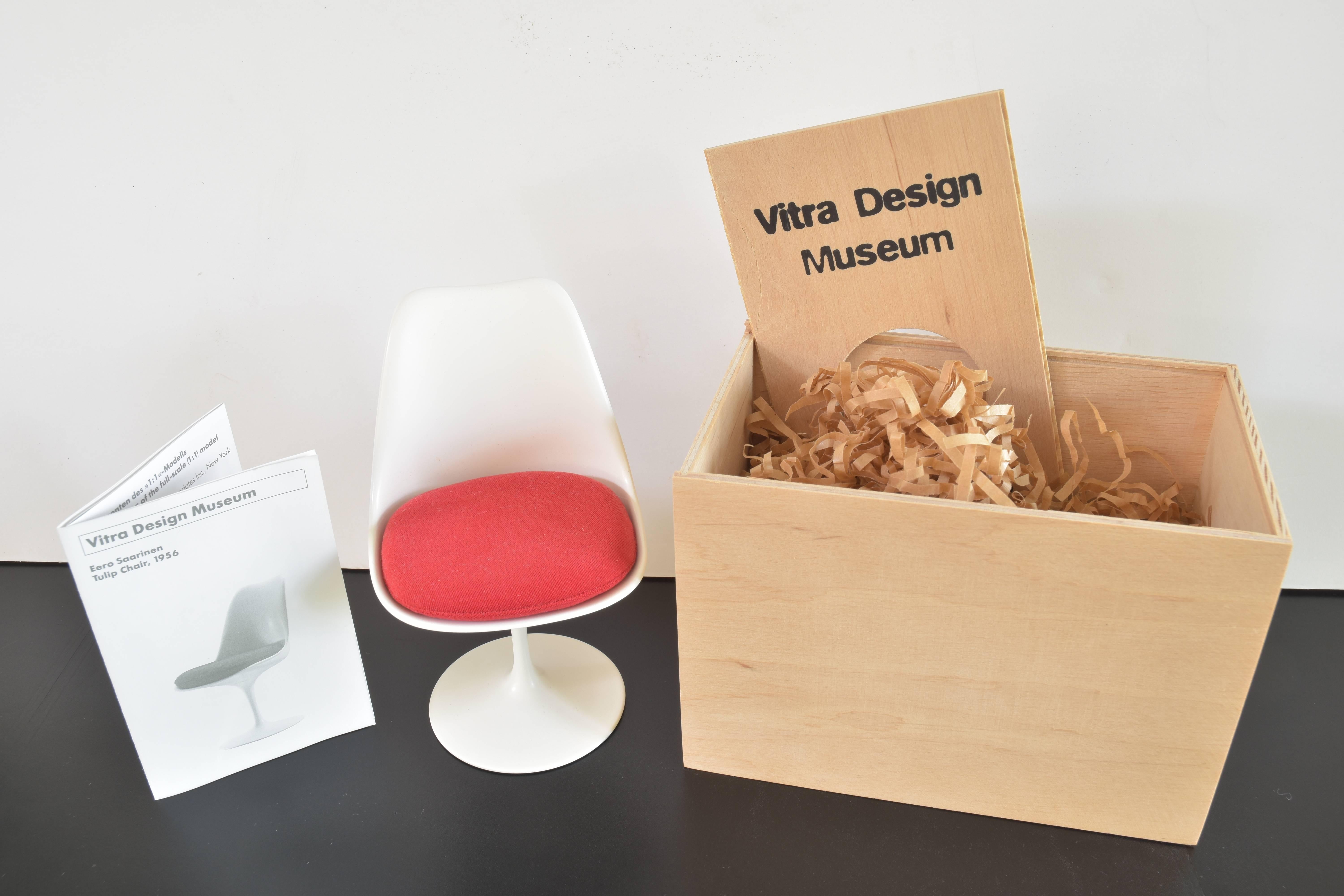 Charming Vitra design museum miniature modeled on the original design of the Eero Saarinen tulip chair manufactured by Knoll Associates Inc. New York.

This piece includes the original wooden box and brochure with the narrative biography of Eero