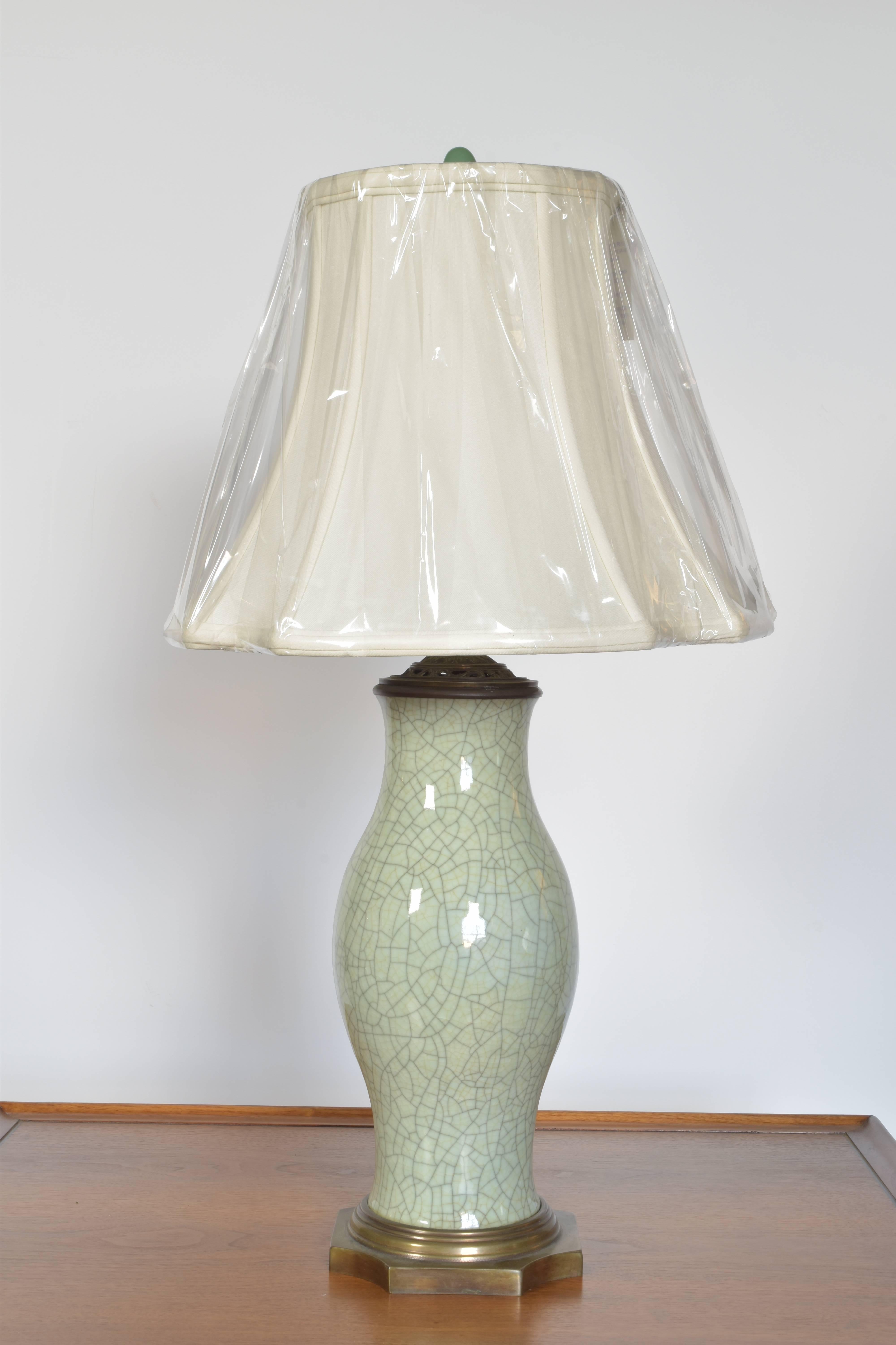 Lovely celadon lamp with cradle glaze on a bronze base with a silk shade and jade finial. Lamp measures 28