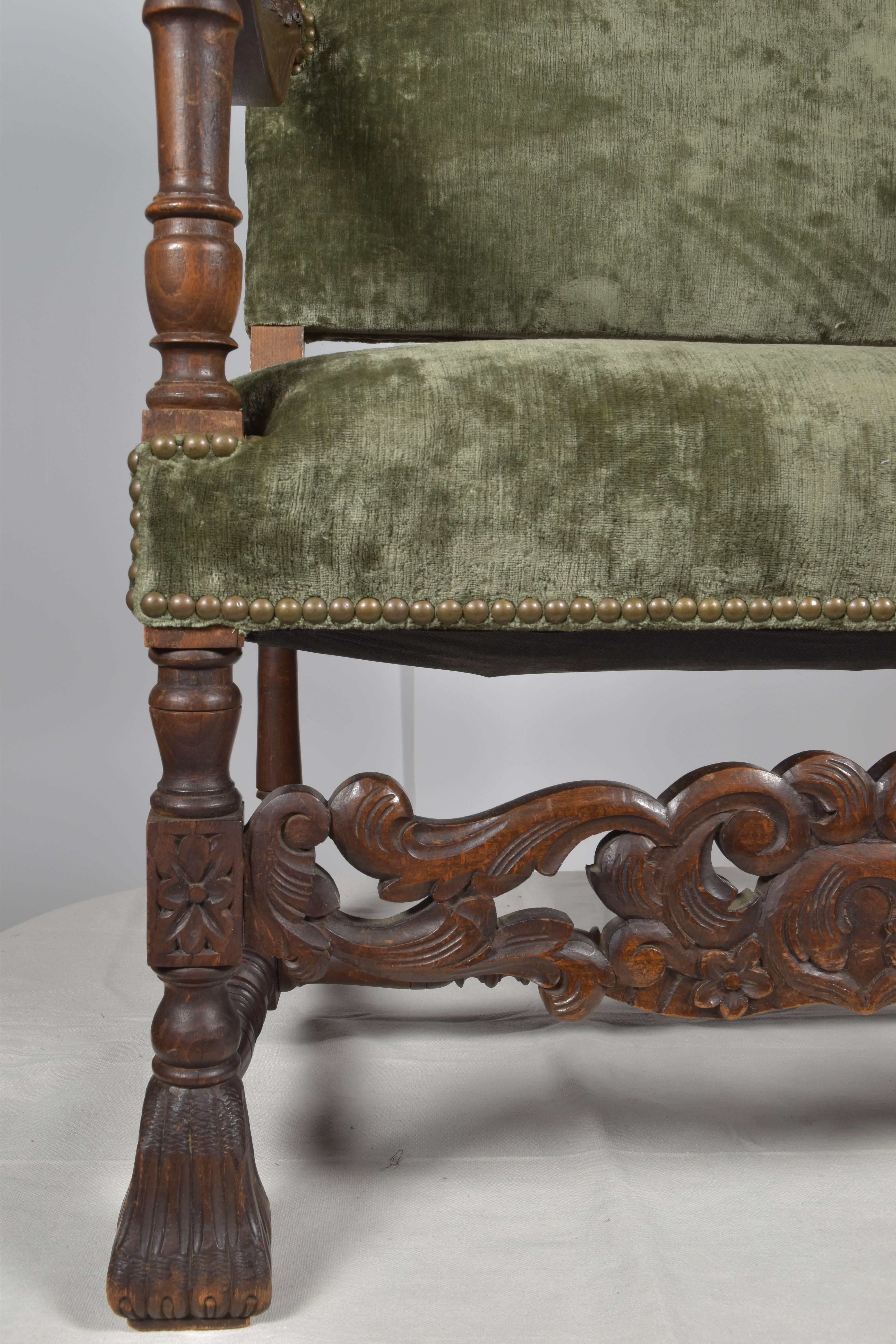 Handsome and large-scale, French armchair. Newly upholstered in green velvet with nailhead trim. Carved details on the armrests and stretcher.