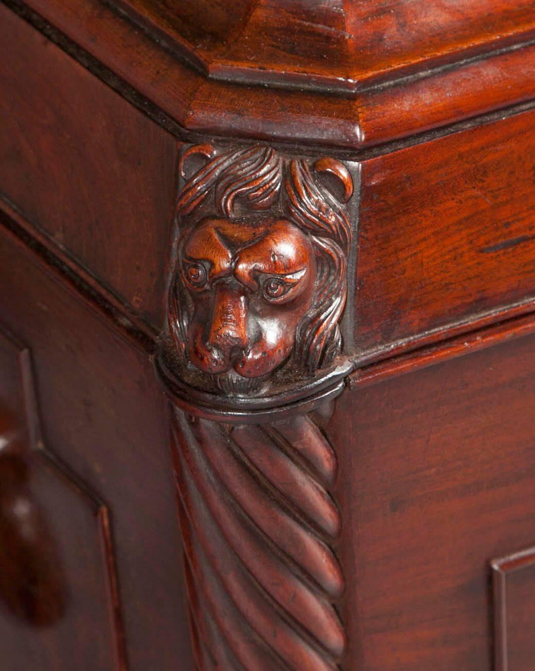 A matched pair of Irish George IV wine coolers, the rectangular hinged tops above a lead lined interior, with tapered and panelled bodies flanked by twisted columns finished with carved lion faces, resting on lions paw feet.
In the manner of Mack,