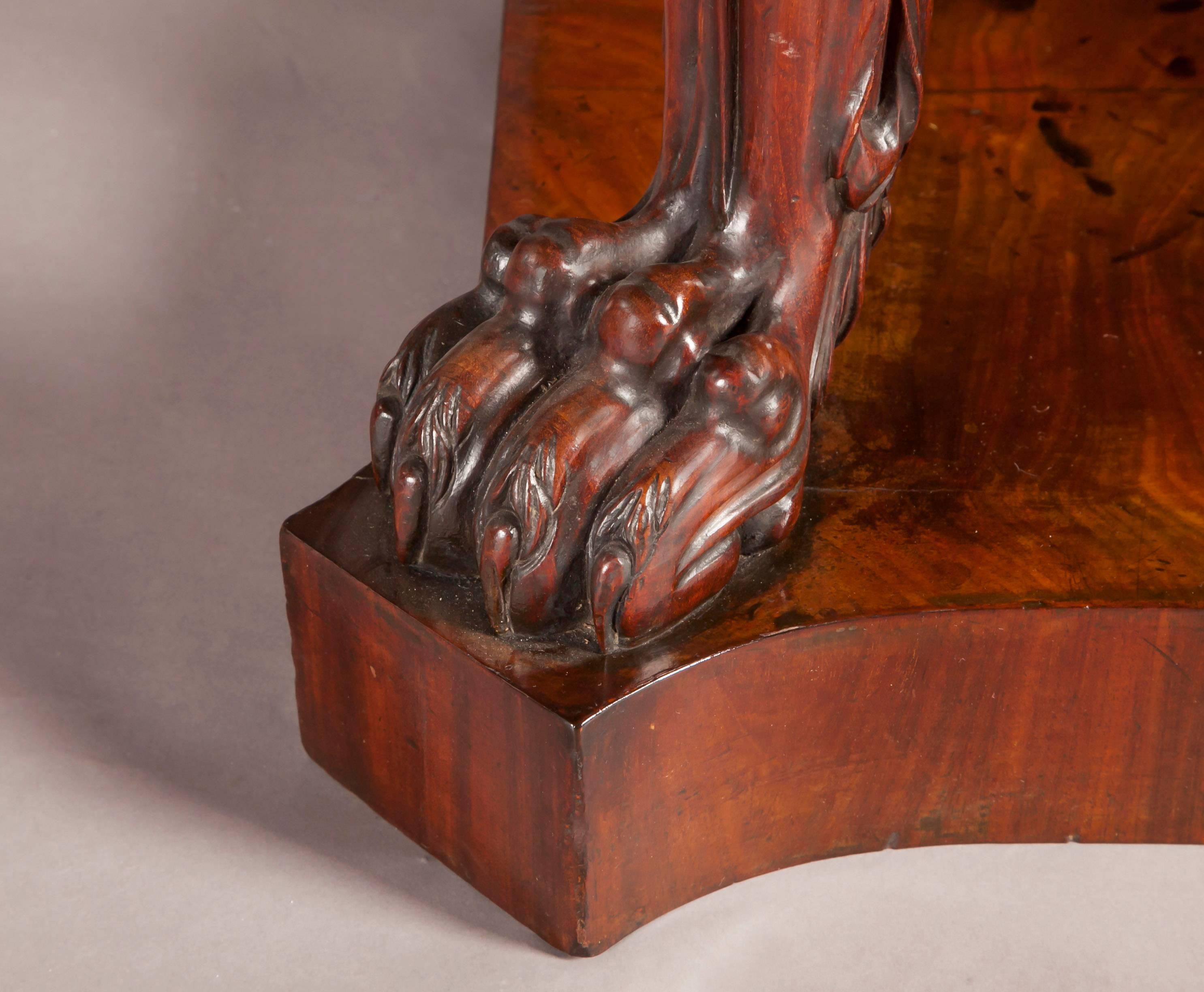 A pair of Irish Regency mahogany console tables, the rectangular Carrara marble tops, 

above a lotus leaf carved frieze, resting on bold Acanthus carved cabriole legs, with

Lions paw feet, resting on a plate-form base.

Probably by Mack,