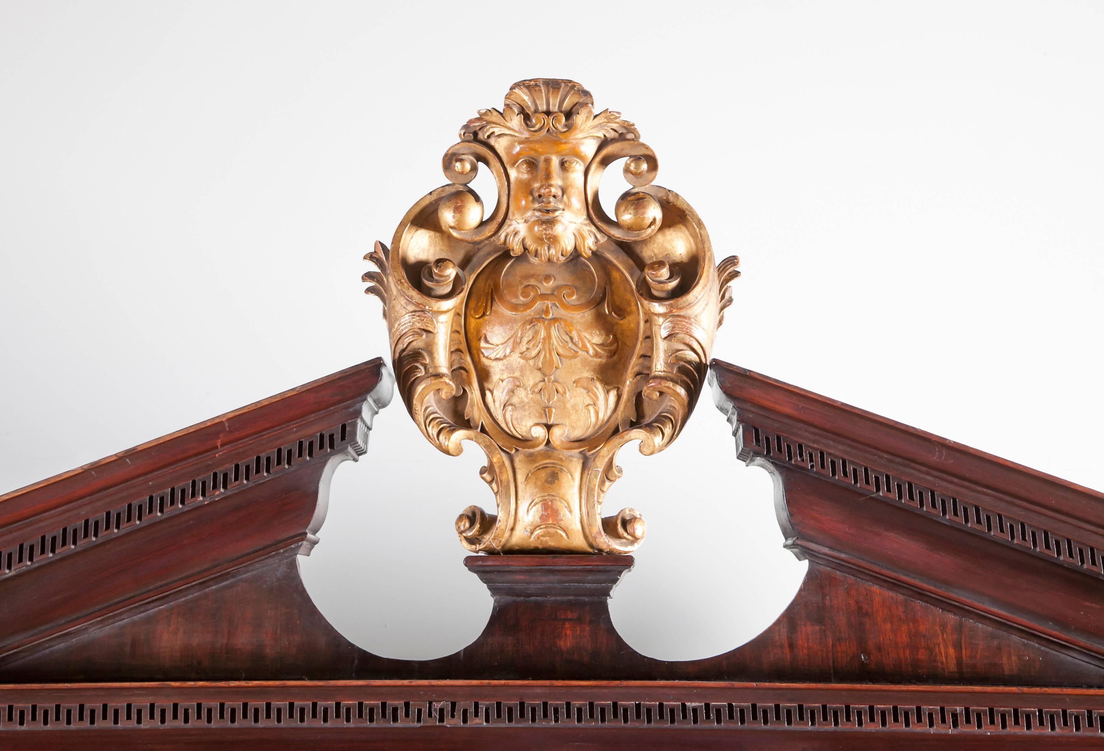 An Irish George II mahogany Bureau bookcase, The architectural top with central giltwood cartouche,

carved with an Irish Mask and scallop shell, above two blind doors with raise panels,

fitted with pigeon holes and drawers, resting on a fall