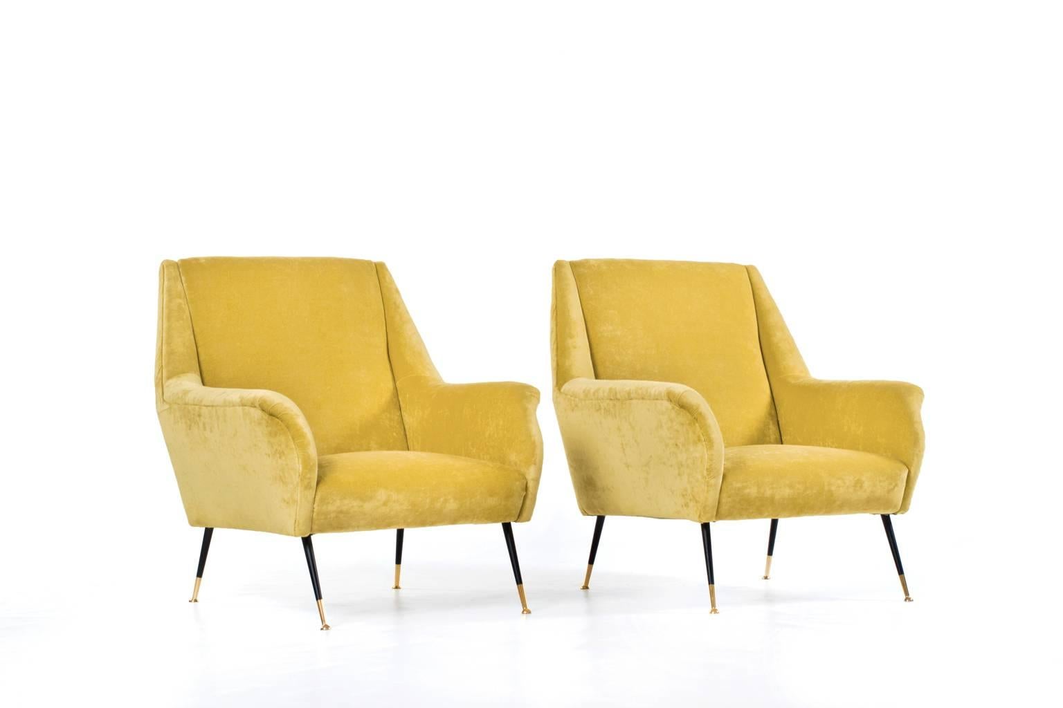 Beautiful pair of Italian lounge chairs in the style of Carlo di Carli, Italy, 1950s. Very elegant form and chic brass legs. Upholstered in warm yellow velours, providing a very comfortable and soft feeling. In excellent condition.

Price for the