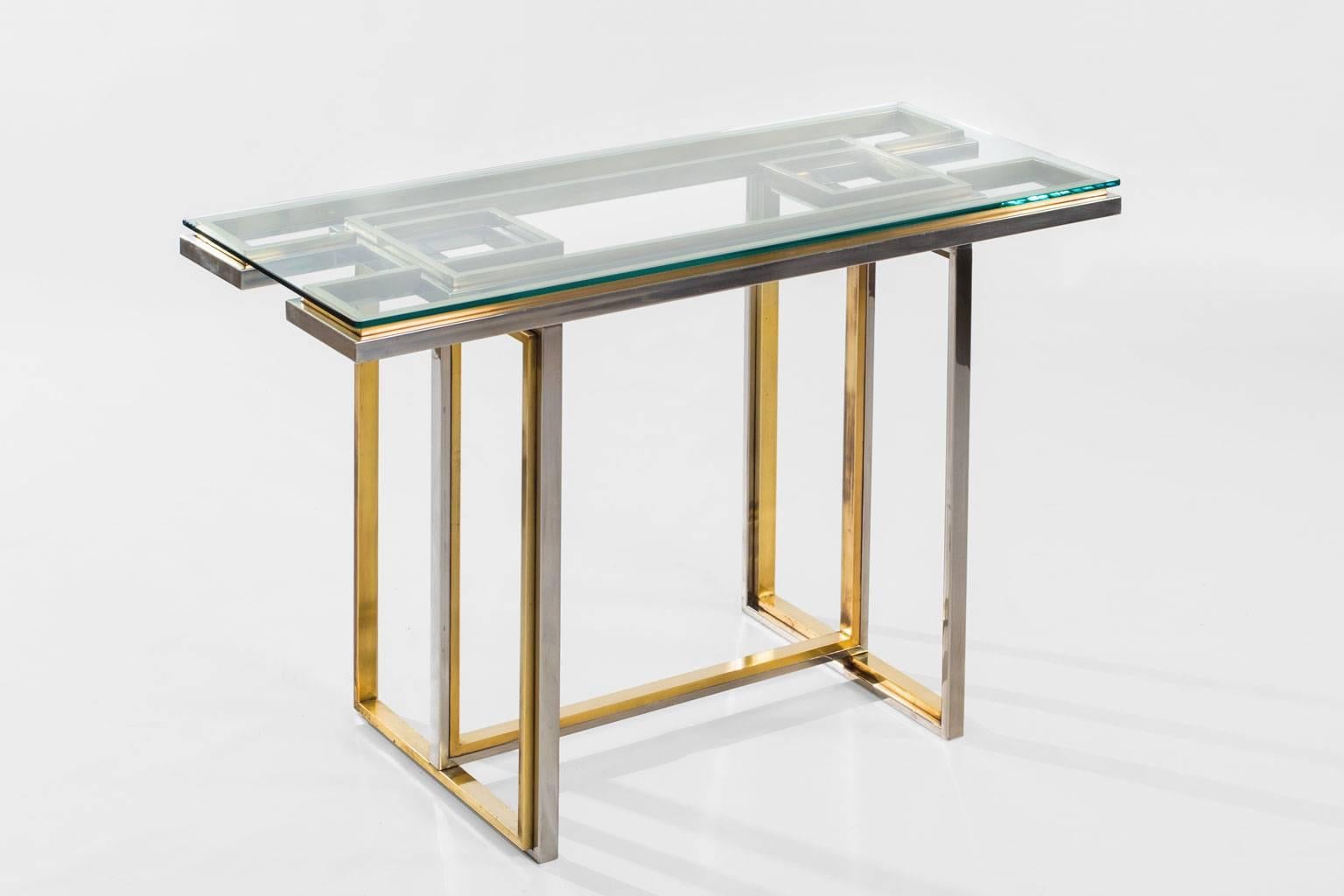 Magnificent console table by Romeo Rega, Italy, 1970s. Made of chrome combined with solid brass. The table is of the highest quality and has a refined and unique Geometric design which gives an interesting play of perspective. In excellent condition.