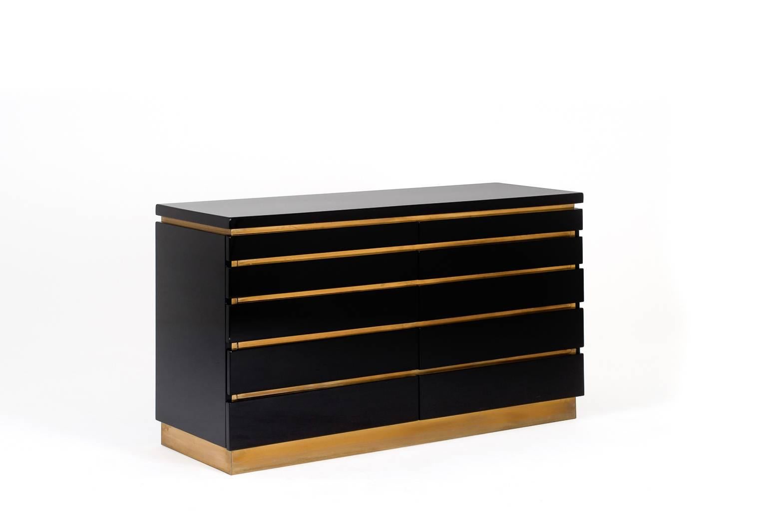 Stunning black lacquered chest of drawers by Jean Claude Mahey, France, 1970s. High quality piece, wooden base finished in a high gloss black lacquer and chic brass details. Provided with ten drawers. In excellent condition with a beautiful warm