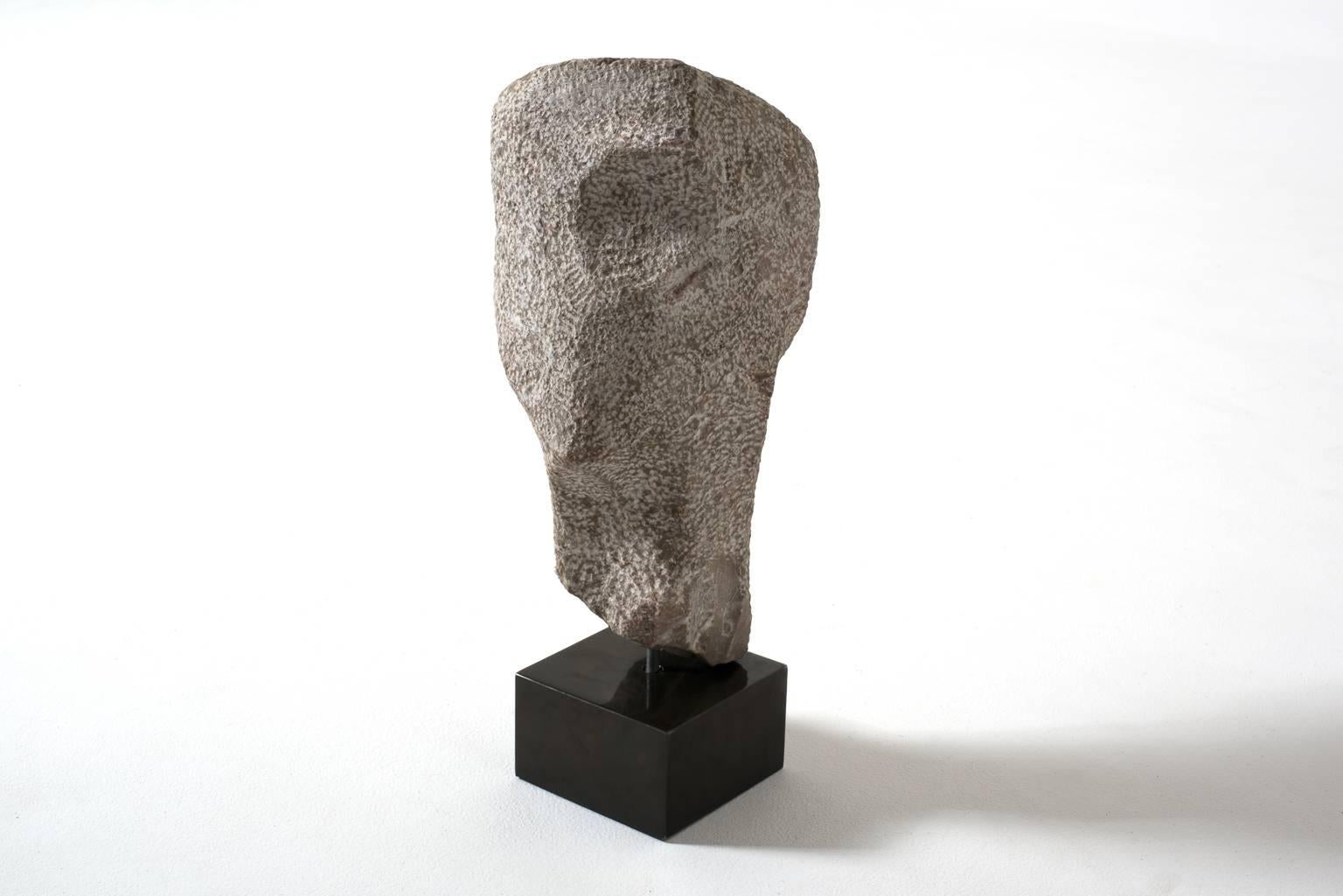 Impressive natural stone sculpture, 1960s. Sculpted out of natural stone with nice traces of the chisel and stands on a patinated metal console. Impressive size with beautiful details of artistic expression. Signed by the artist. In excellent