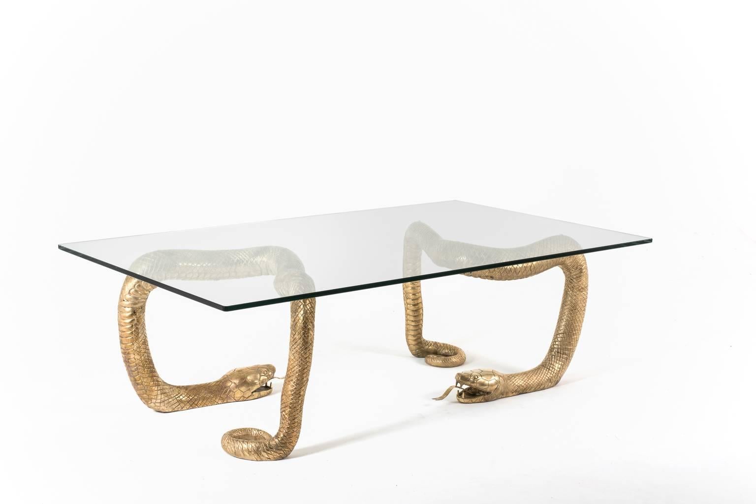 Exceptional brass ‘Python’ coffee table attributed to Alain Chervet, France, 1970s. The table comprised of two impressive and highly detailed brass snake sculptures, all handcrafted. The snakes support a big rectangular glass top. In excellent