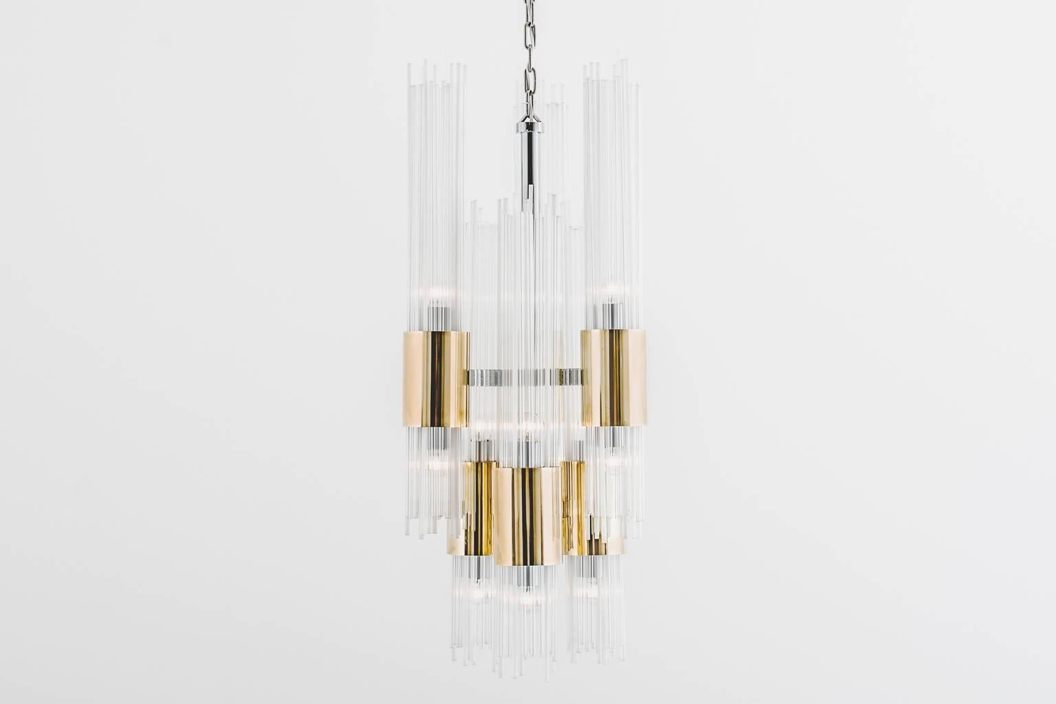 Stunning chandelier in an imposing ‘Art Deco’ style, Italy, 1970s. This chandelier is made out of clear and opal white glass tubes mounted in solid brass cylinders. Nice combination between the ‘warm’ brass and the ‘cool’ chrome. The six brass tubes