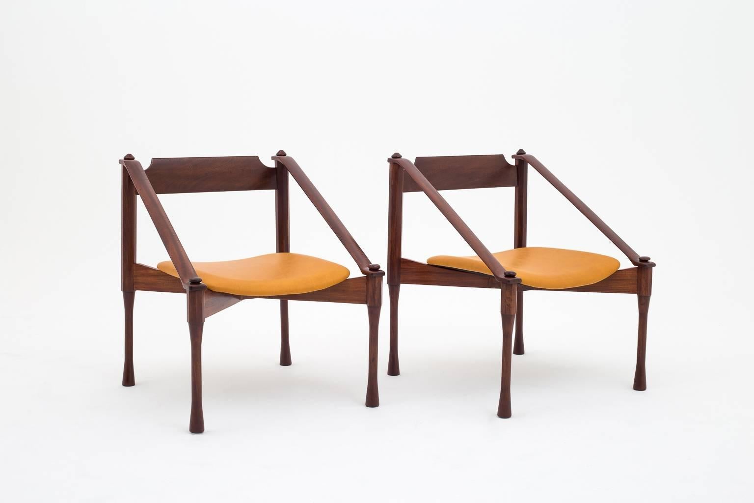 Rare pair of armchairs by Giulio Moscatelli, Italy, 1960.
Refined and distinctive shape and combination of forms.
The chairs are made from solid Indian Rosewood and are upholstered with a smooth caramel colored leather. In excellent condition.
 