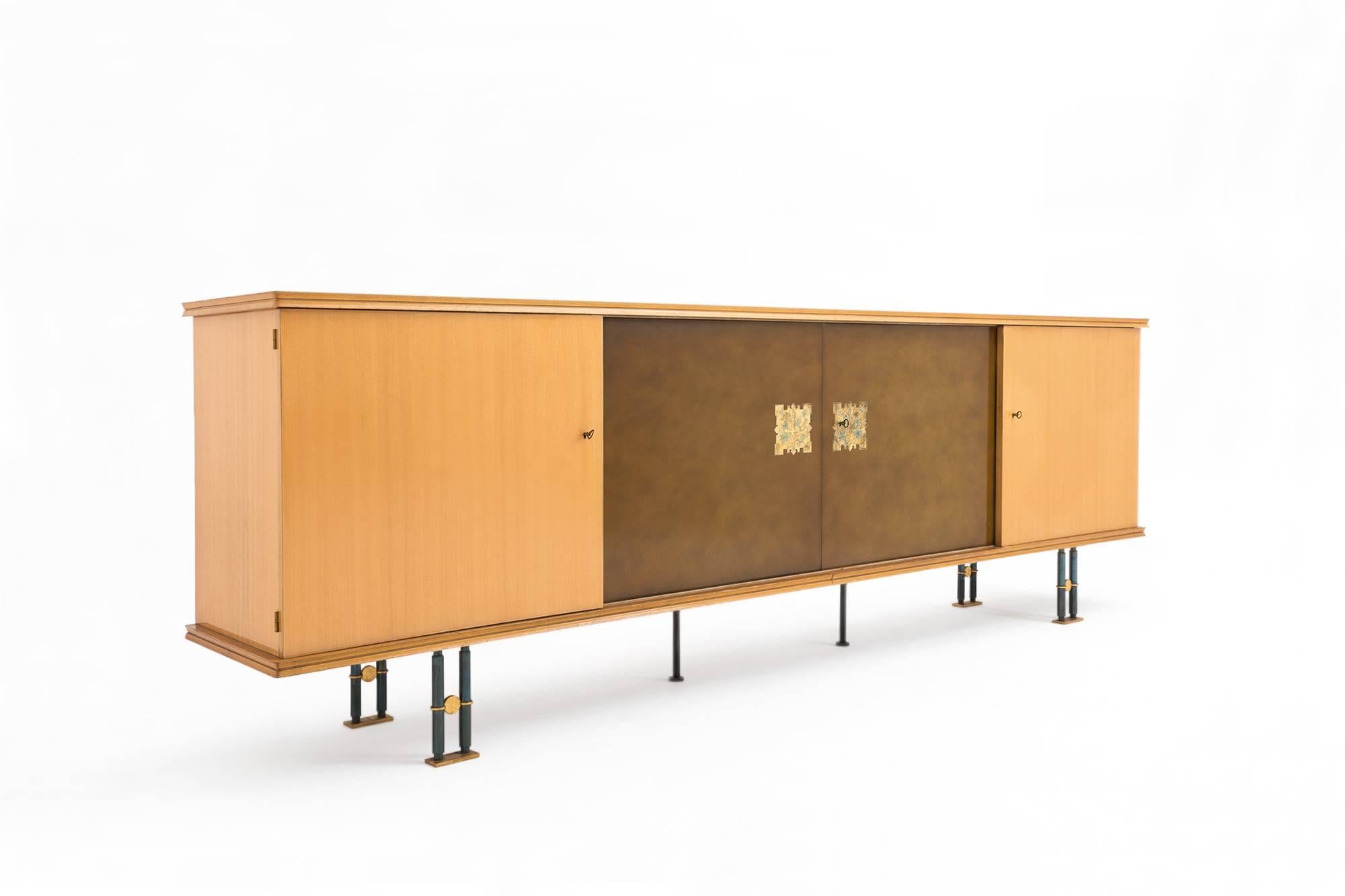 Outstanding sideboard by Jules Leleu, Paris, 1950s. Whole made from high quality Maple veneer, the two middle artistic lacquered doors are made by Paul Etienne Sain and Henri Tambute and have wonderful small drawings in gild and azure. The cabinet