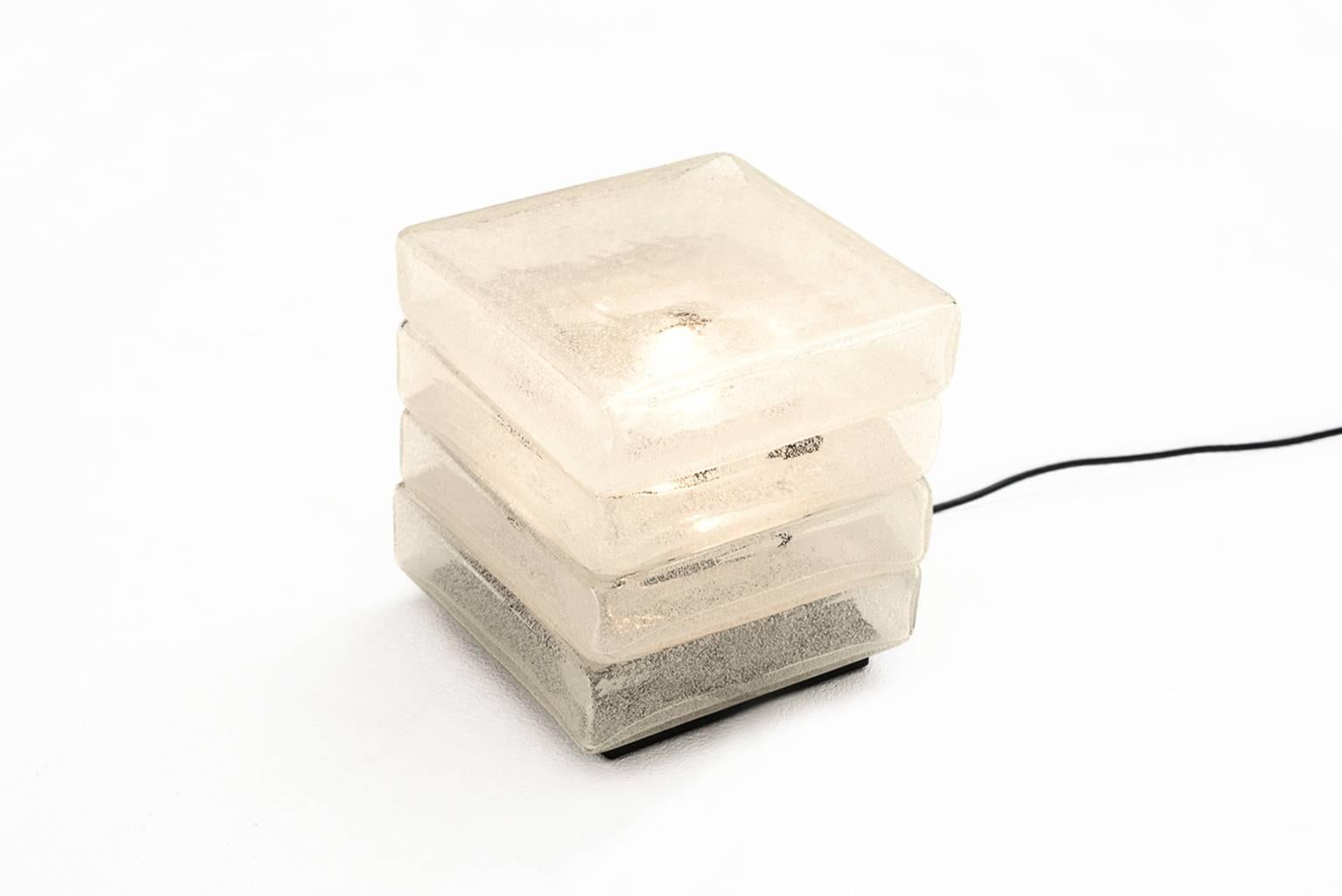 Cubic table lamp by Carlo Nason for A.V. Mazzega, Italy, 1960s.
Composed from four handblown Murano glass pieces stacked together into a cube. This is a rare Pulegoso glass version; glass with a lot of bubbles which work like a filter. The lamp is