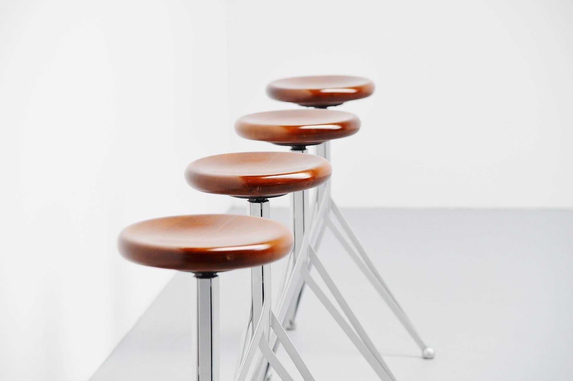 Rare set of four bar stools designed by English designer Ron Arad for Zeus, Italy, 1994. These stools are from the Anonimus series by Arad and are no longer in production. The stools have a grey lacquered metal base, brown stained wooden seats