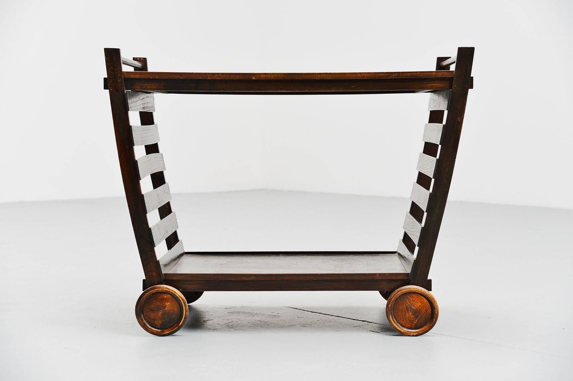 Ultra rare and quite unique tea cart designed by Gerrit Thomas Rietveld, designed and made probably by Gerard van de Groenekan for Metz & Co ca 1945. This tea cart is one of the very few known to still exist because the wood is very fragile and