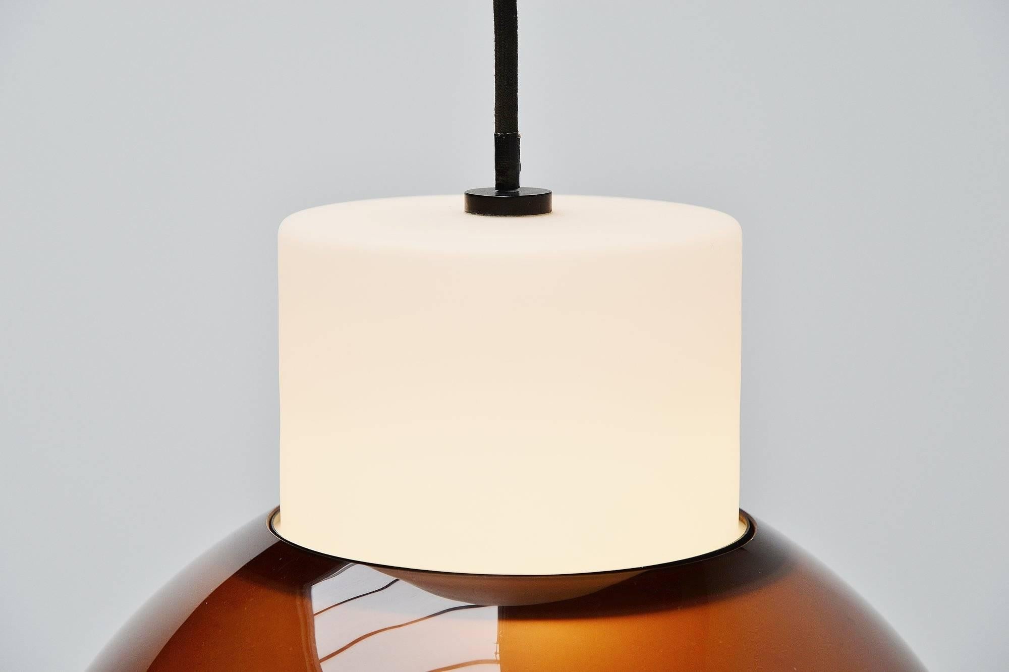 Nice pendant lamp model 2103 designed by Gino Sarfatti, manufactured by Arteluce, Italy, 1958. This light exists in three parts, a white opaline glass shade, a black lacquered aluminum ring and a smokey brown methacrylate shade. The lamp gives very
