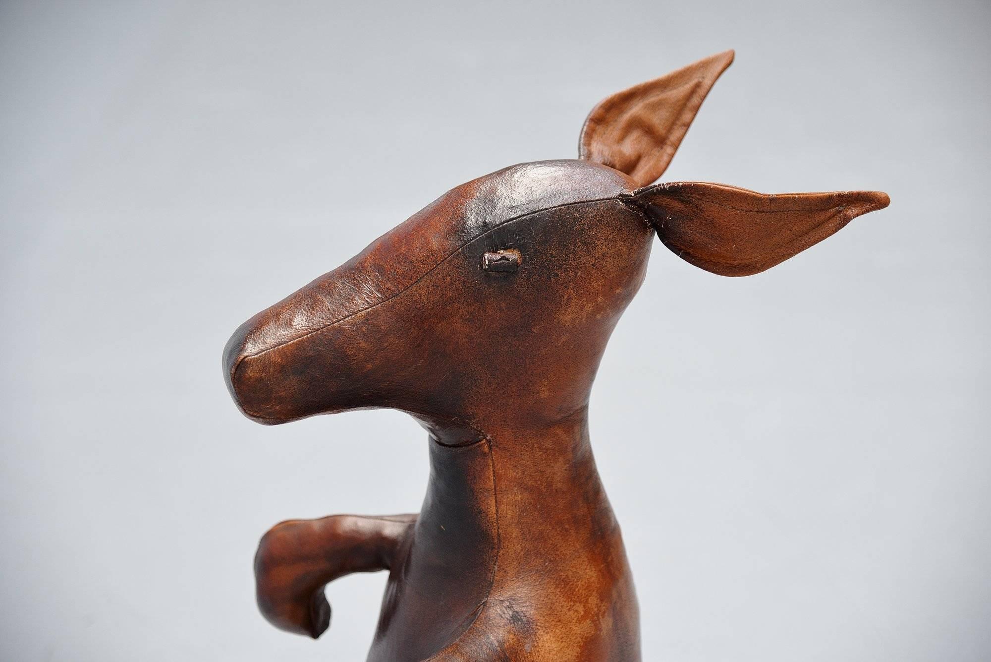 Here for a very nice and extremely decorative leather magazine holder Kangaroo designed by Dimitri Omersa, England, 1960. The Kangaroo is one of the rarer and nicest animals produced by Dimitri Omersa for Liberty’s. This kangaroo was made of top