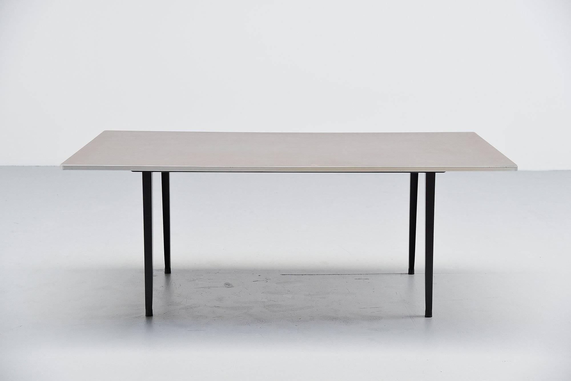 Nice and rare Industrial dining or working table designed by Friso Kramer for Ahrend de Cirkel, Holland, 1955. This table is the second largest version made, 200 cm long top. This has a rectangular shaped top, finished with dark grey linoleum and an