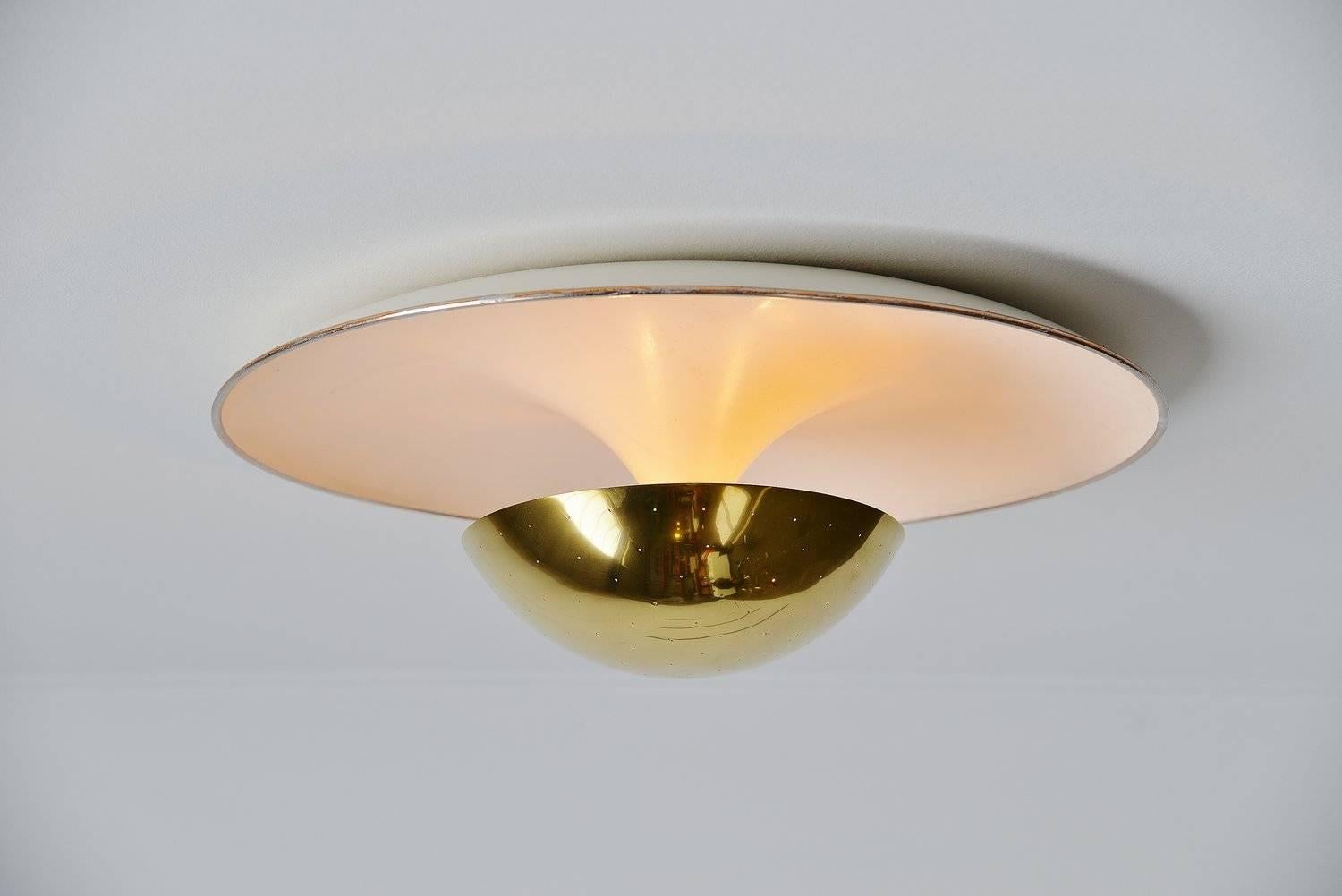 Rare large ceiling lamp designed by Gino Sarfatti for Arteluce, Milano, 1950. This very nice dish shaped ceiling lamp is Mod. No. 155 and was made of white lacquered aluminum and brass edge and diffuser shade. This lamp gives fantastic light when