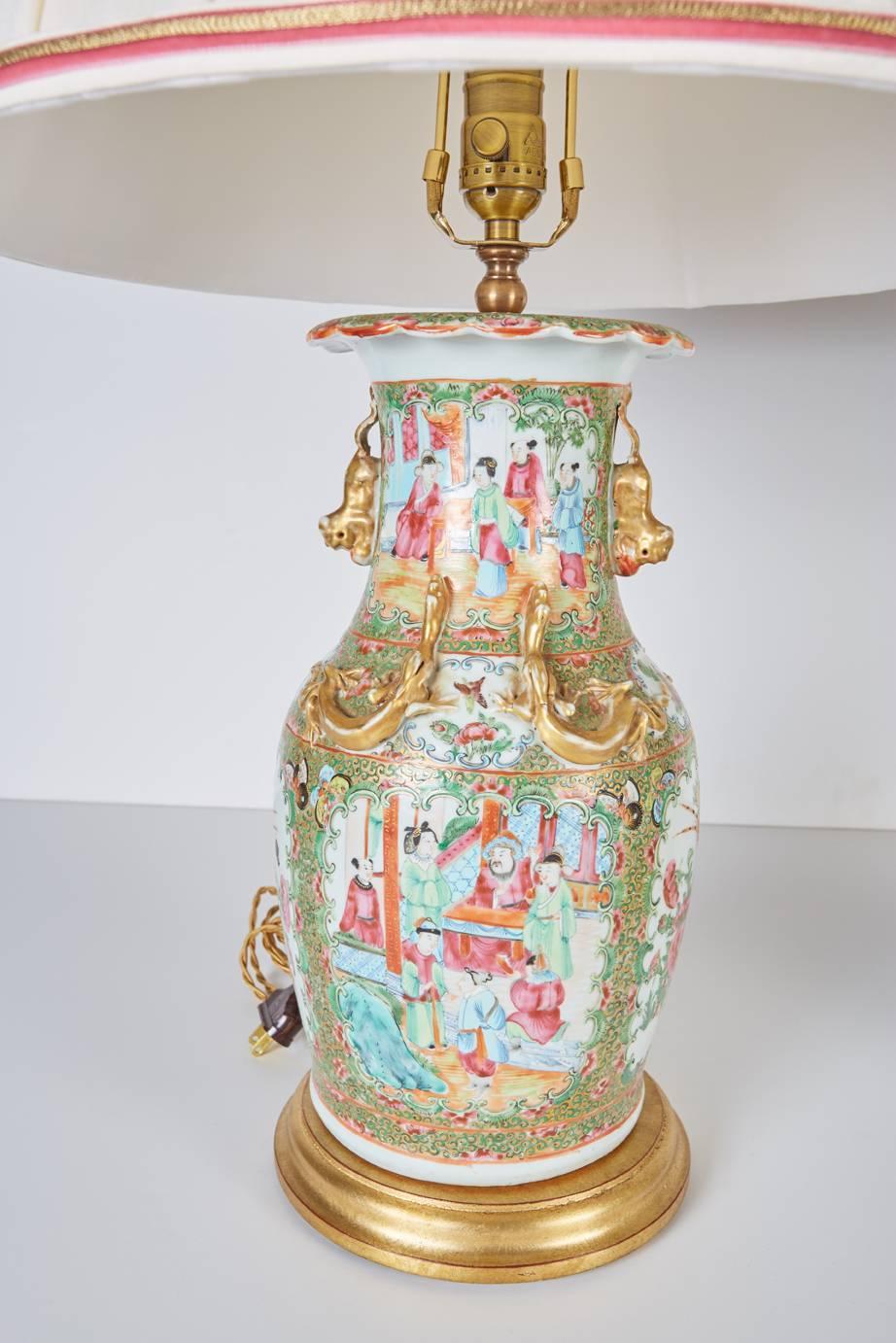 Pair Antique Chinese Export Rose Mandarin Vases now mounted as lamps on custom gilt wood bases and with custom hand smocked cream colored silk shades trimmed in pink ribbon and antique metallic gold colored tape.