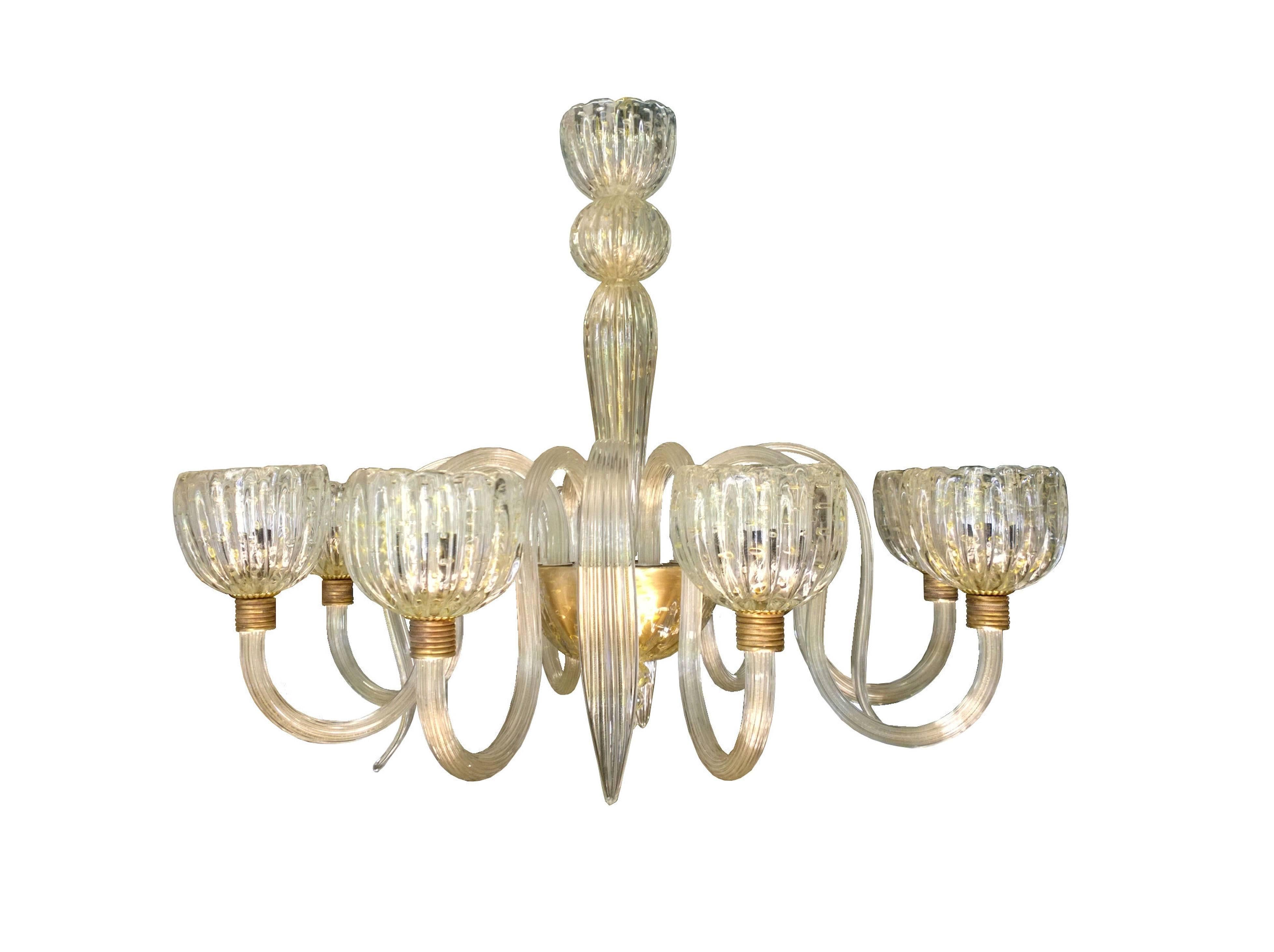 Large eight-arm glass chandelier in lightly gold flecked Murano glass with interspersed glass leaf ornaments. Candle cups and other elements are crafted of gold flecked bubble glass. Gilt fittings give the fixture's glass a soft golden glow.