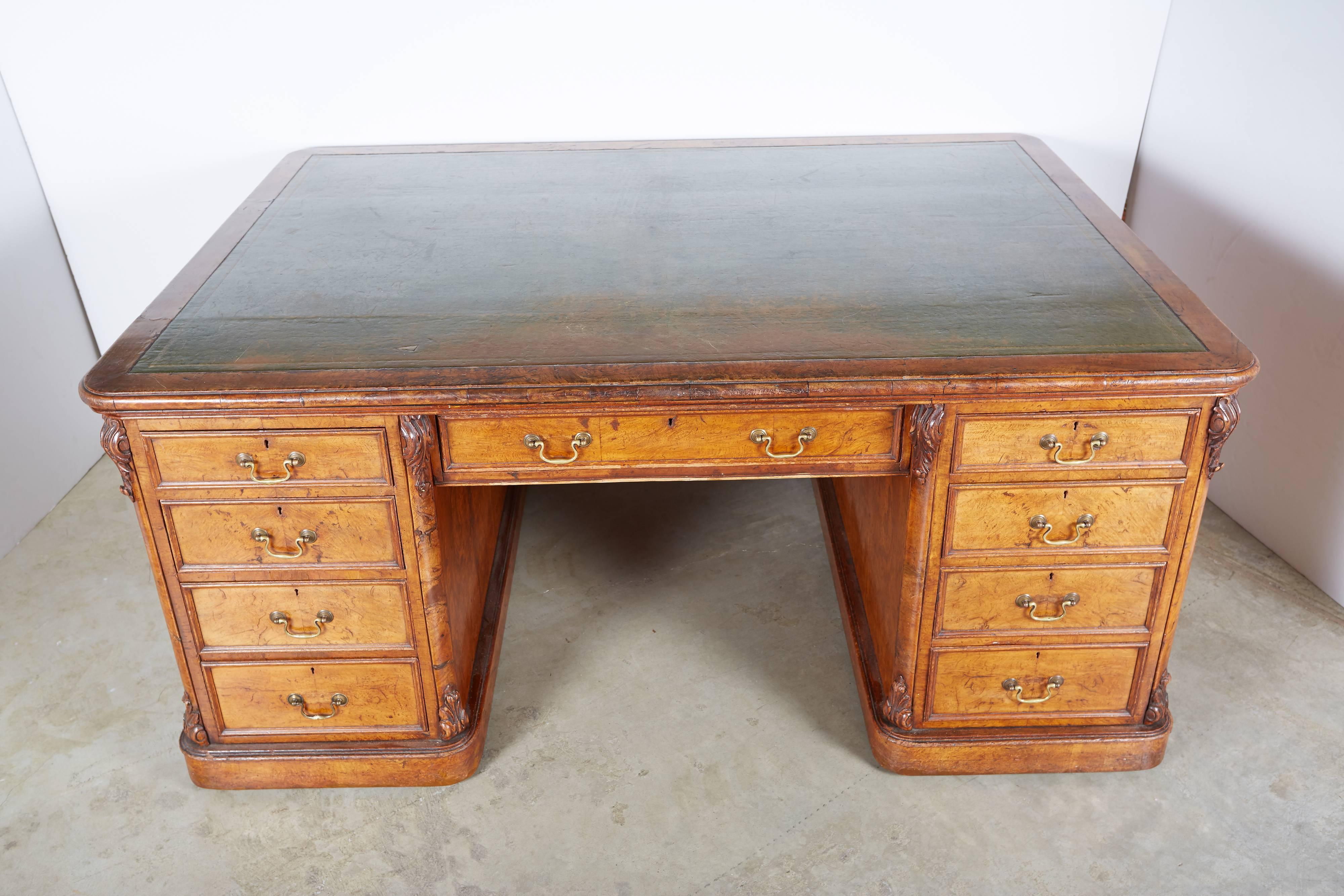 Early 19th century burl walnut double sided partners desk with a central drawer on both sides. One side is fitted with columns of drawers on either side of the central drawer and the other side is fitted with cupboards on either side of the center