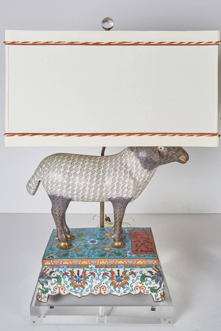 Antique Chinese cloisonné lambs on cloisonné bases bearing Arabic calligraphy and probably made for the Arabic market. Newly mounted on thick, custom Lucite bases with custom, off-white silk shades trimmed in brown and white twisted cord.