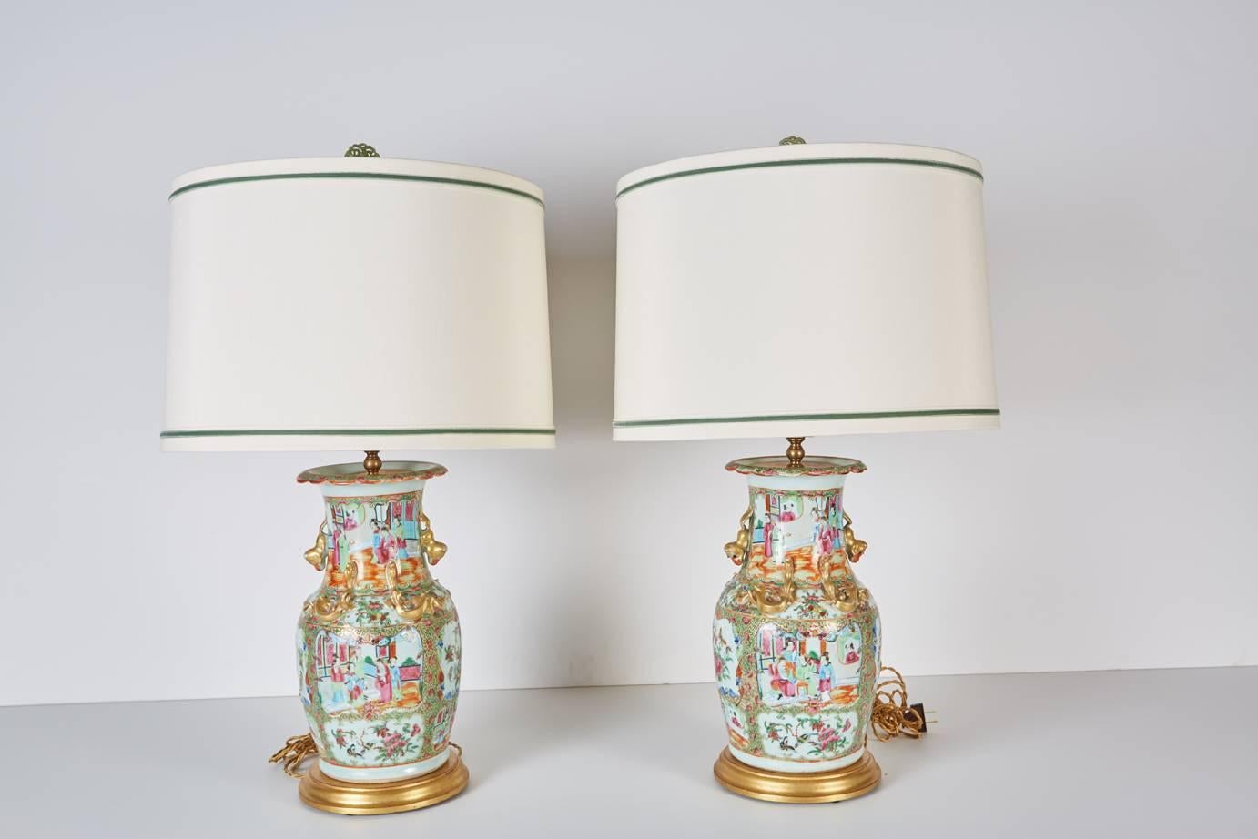 Pair of Fine Chinese export vases in the rose mandarin pattern newly mounted as lamps on custom giltwood bases with custom silk shades trimmed in green velvet ribbon.