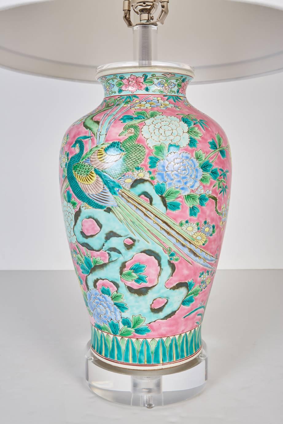 Antique Japanese vase newly custom mounted as a lamp. Painted in a Chinese style with multicolored floral and bird motifs against a vibrant pink background now custom mounted as lamp. Lamp fitted with new custom Lucite base and new custom silk shade