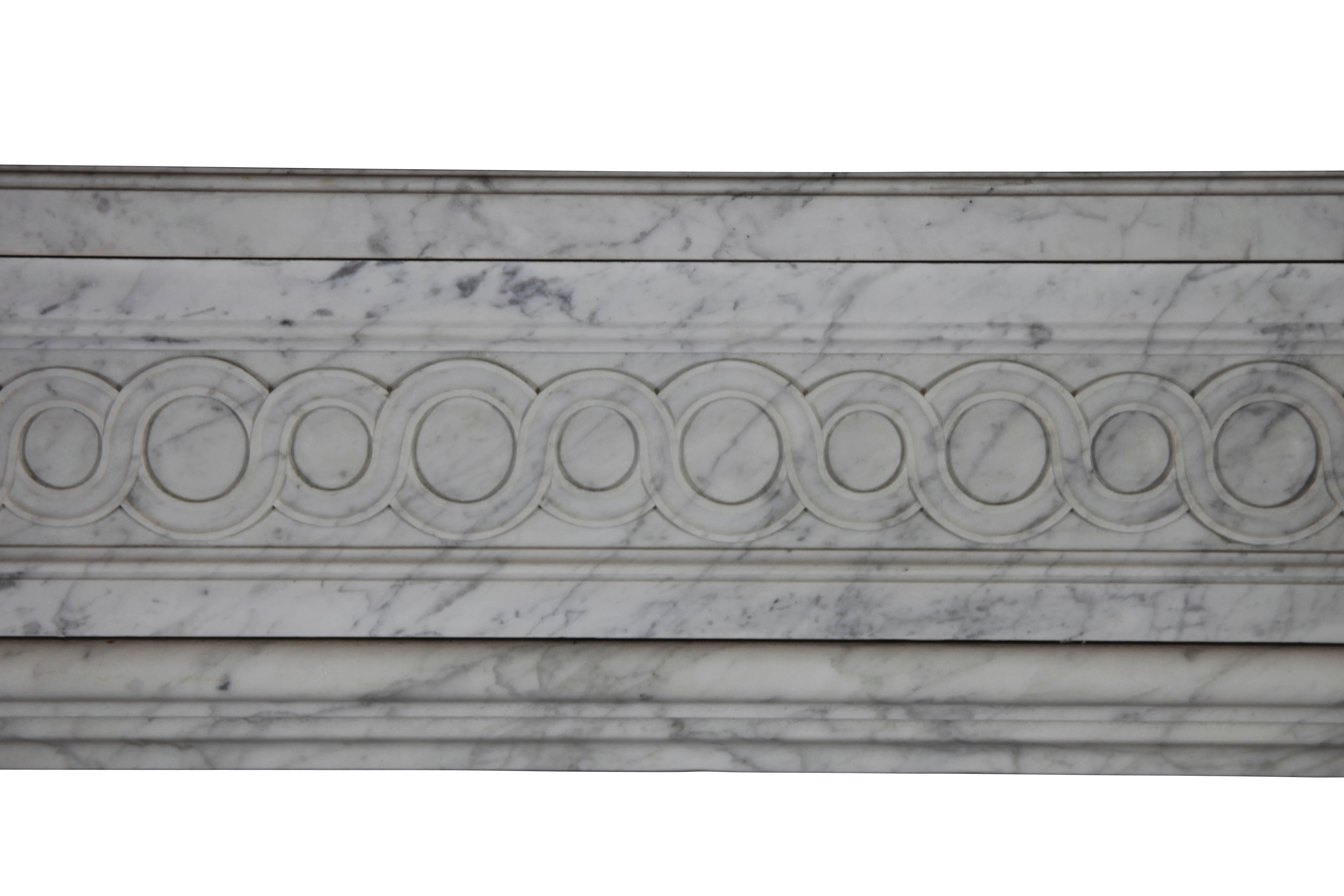This is a very fine antique fireplace surround in Carrara marble. See the fine carving on the front. The macarons are double and in two different sizes.
This mantel is perfect fit for different type of interior designs - from classical to American