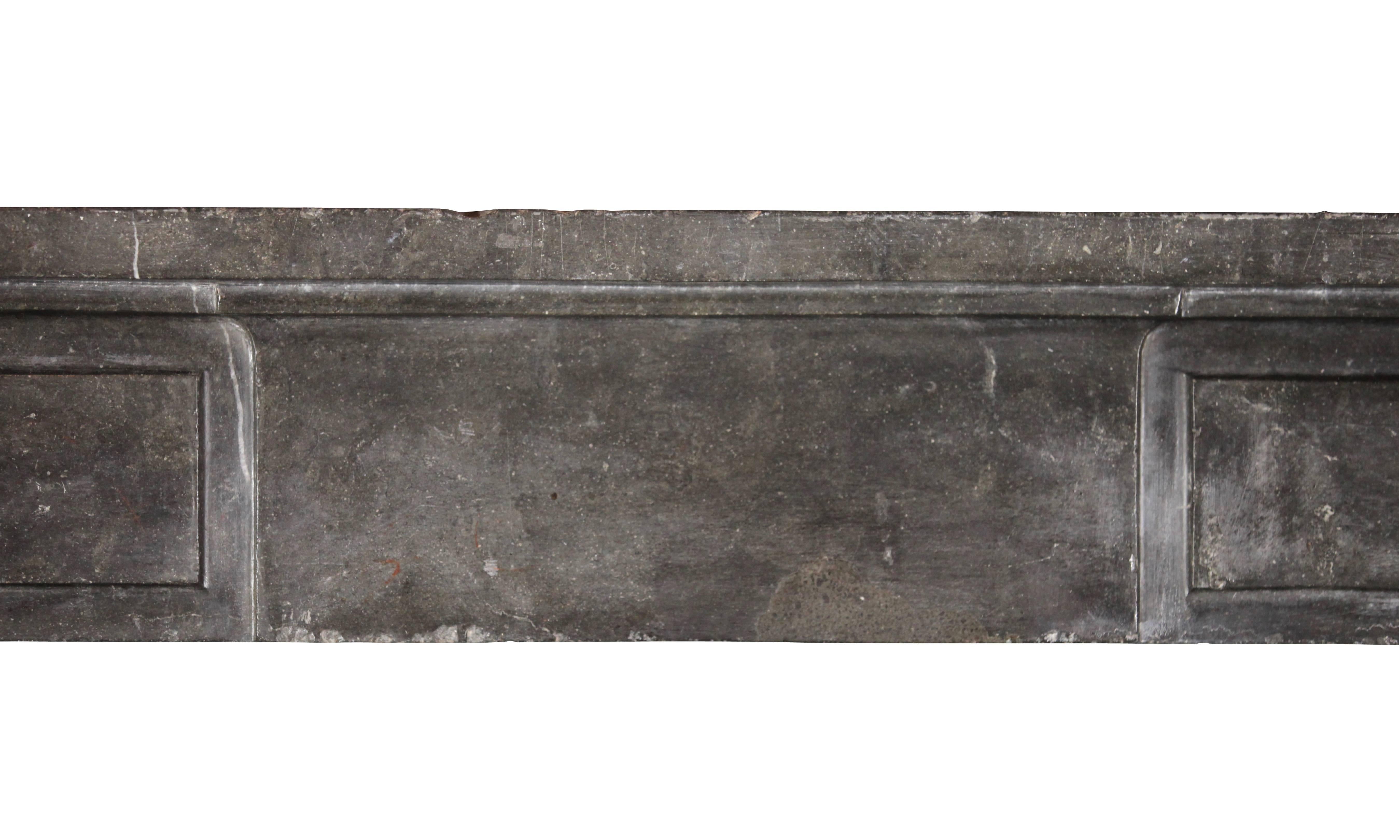 This original fireplace surround is made out of a very beautiful oxidized hard stone from the Beaujolais region. The stone is hard and shines the light back into the room. The straight lines are also suitable for modern interior