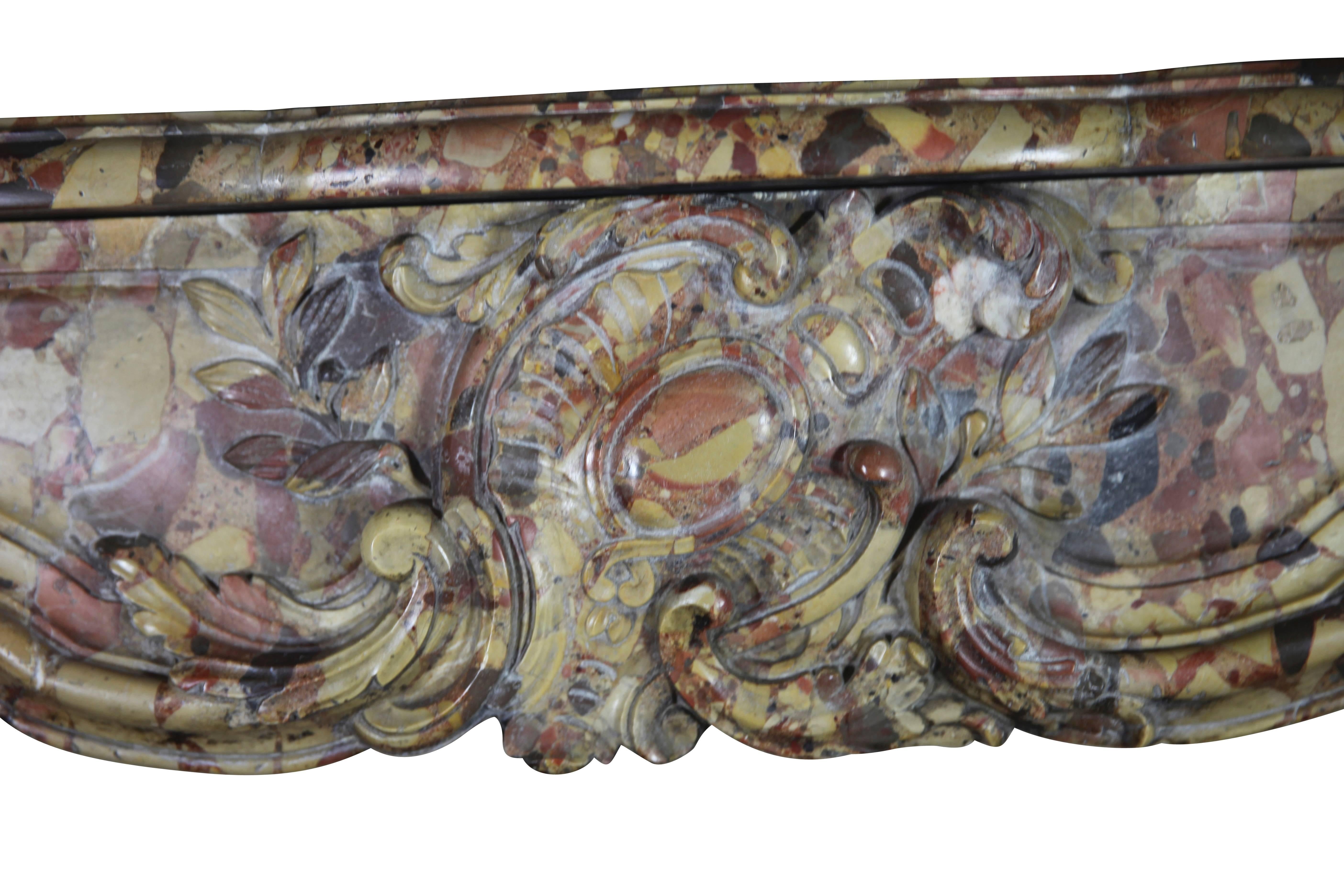 This mantel is for the connoisseur a very exceptional one and this on all levels:
The marble; original 18th century Royal Breche D'Alepp marble,
Dimensions; suitable for a small but high end office whether in a Classic environment or among great