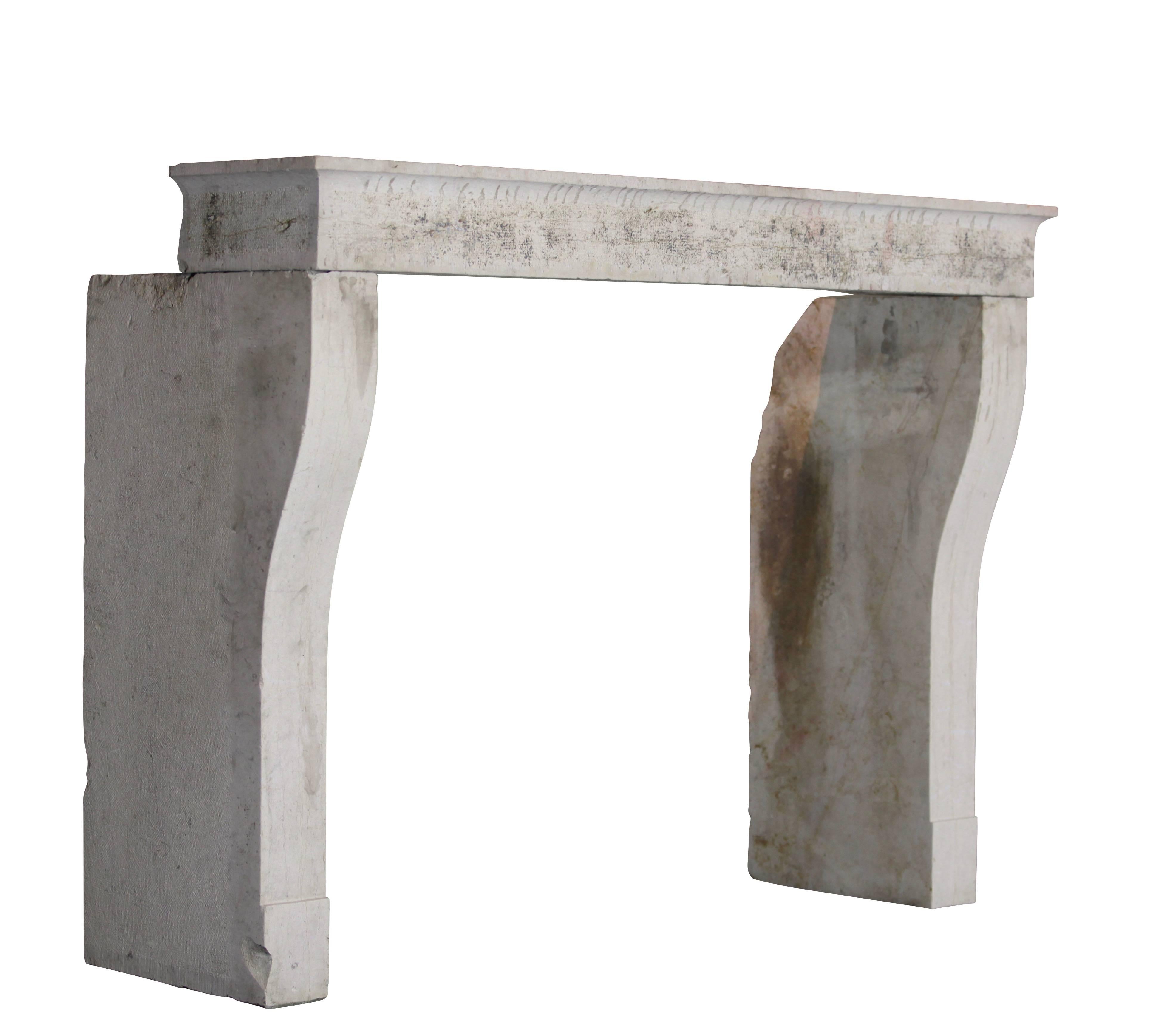 This antique fireplace surround is from a French country house in Burgundy. The hard stone looks like lime stone. All pieces have a very nice finish: remains of original patina, pointed and hammered. It was built in the Louis XIII period, 17th