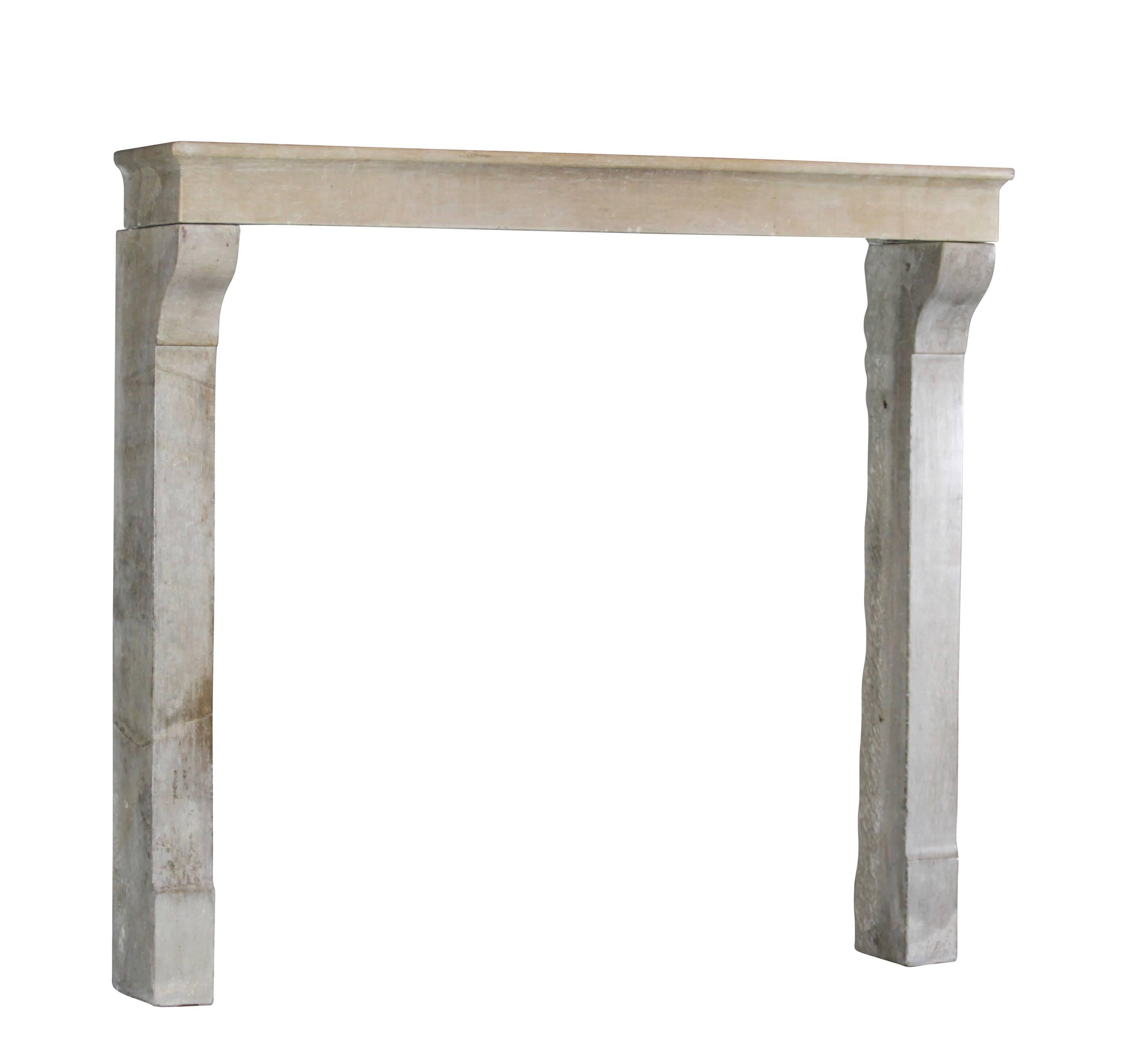 Antique rustic and country but elegant fireplace surround in limestone from the Alsace region. 
Had a restoration on the legs.
Measures:
145 cm Exterior Width 57.08 Inch
132 cm Exterior Height 51.96 Inch
121 cm Interior Width 47.63 Inch
120 cm