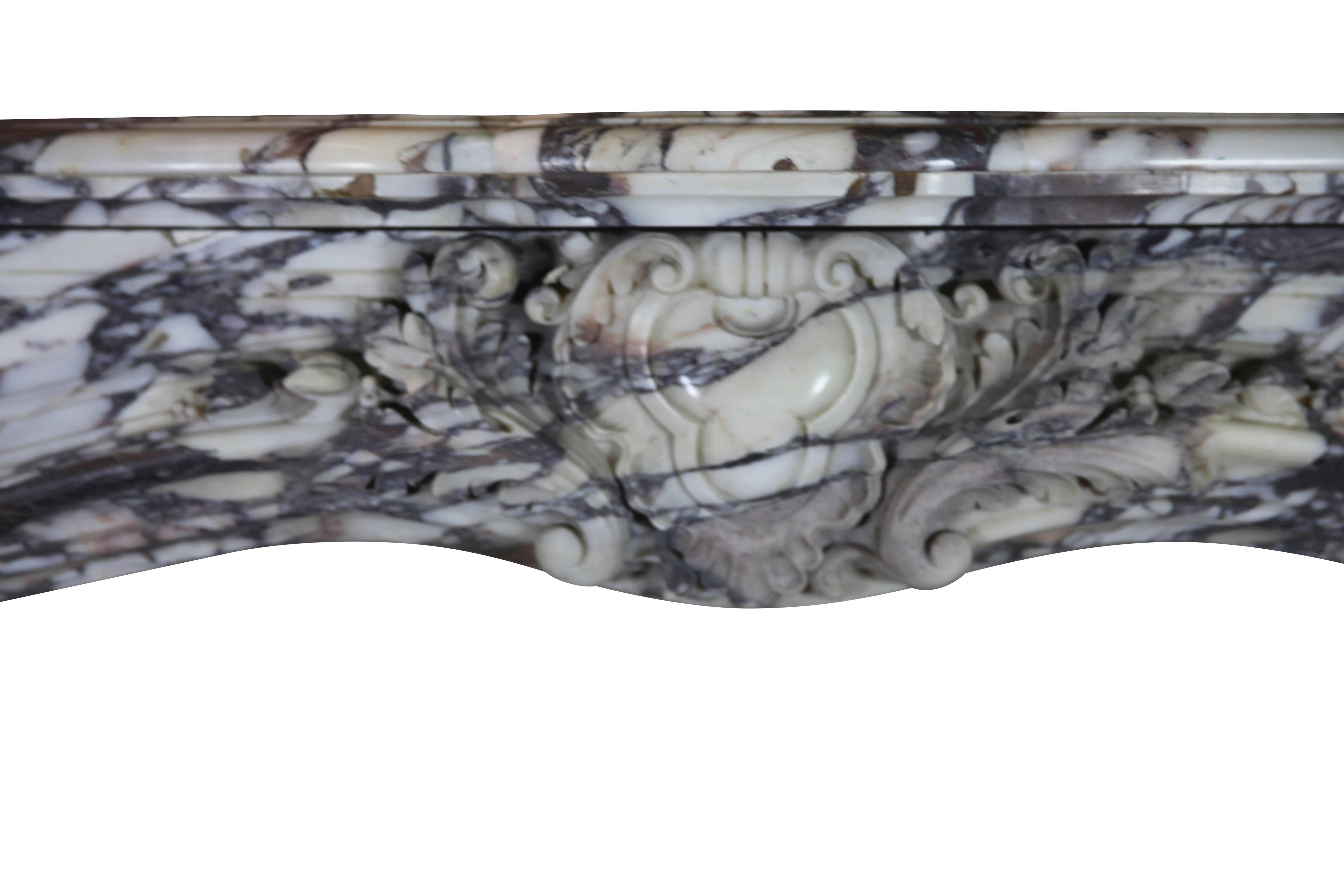 Original antique fireplace surround in the Royal Breche violet marble. This mantle was installed in a panel room. The colors of the Royal Brêche violet marble are deep and rich. A perfect fit for an opulent timeless interior design. This