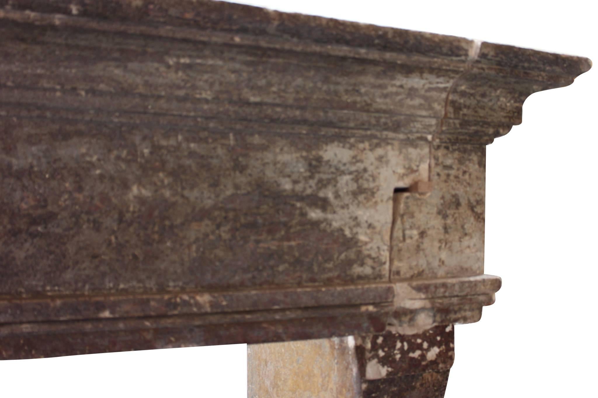 This is a nice French Country Louis XIII period fireplace surround in limestone with original patina. The left side was installed against a wall but is now restored. The remains of the original patina is an extra. Ones this one is re-installed it is
