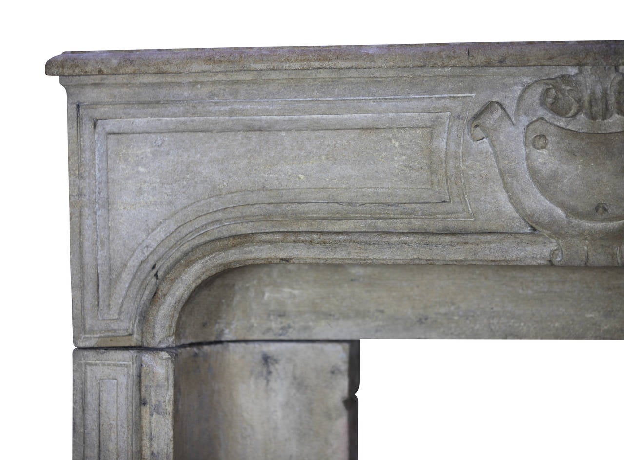 This petite original fireplace surround is from the Louis XIV period and transition Regency period in the 18th century. It is a very unique and strong mantel and perfect for a small fire box. Extra small mantel (fireplace) with nice patina remains