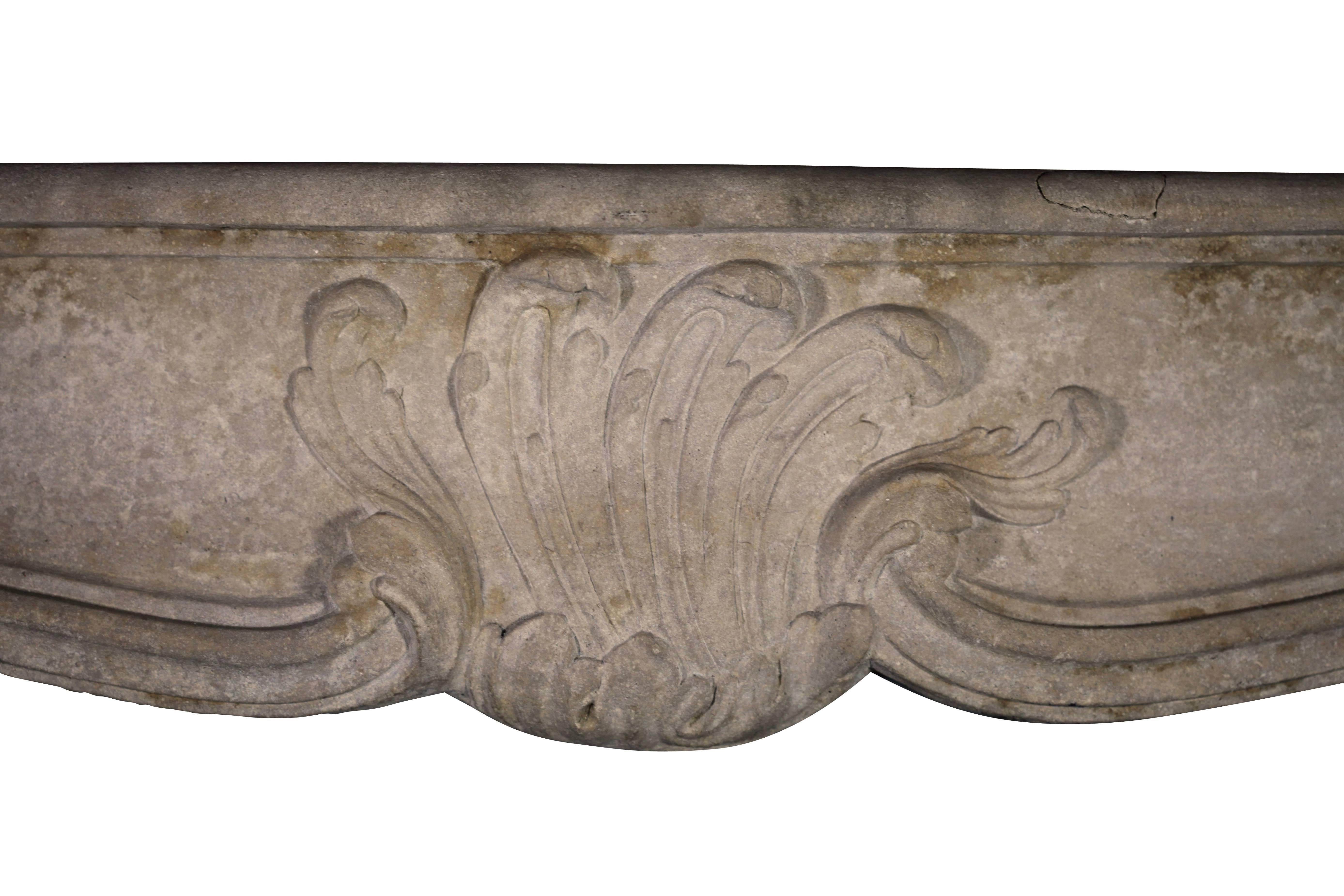 A fine antique fireplace surround in limestone from the Vosges region with decorative flower motive carving from the Regency period. The mantel has a nice patina and the French look to create a cosy room with style.
Measures:
166 cm EW