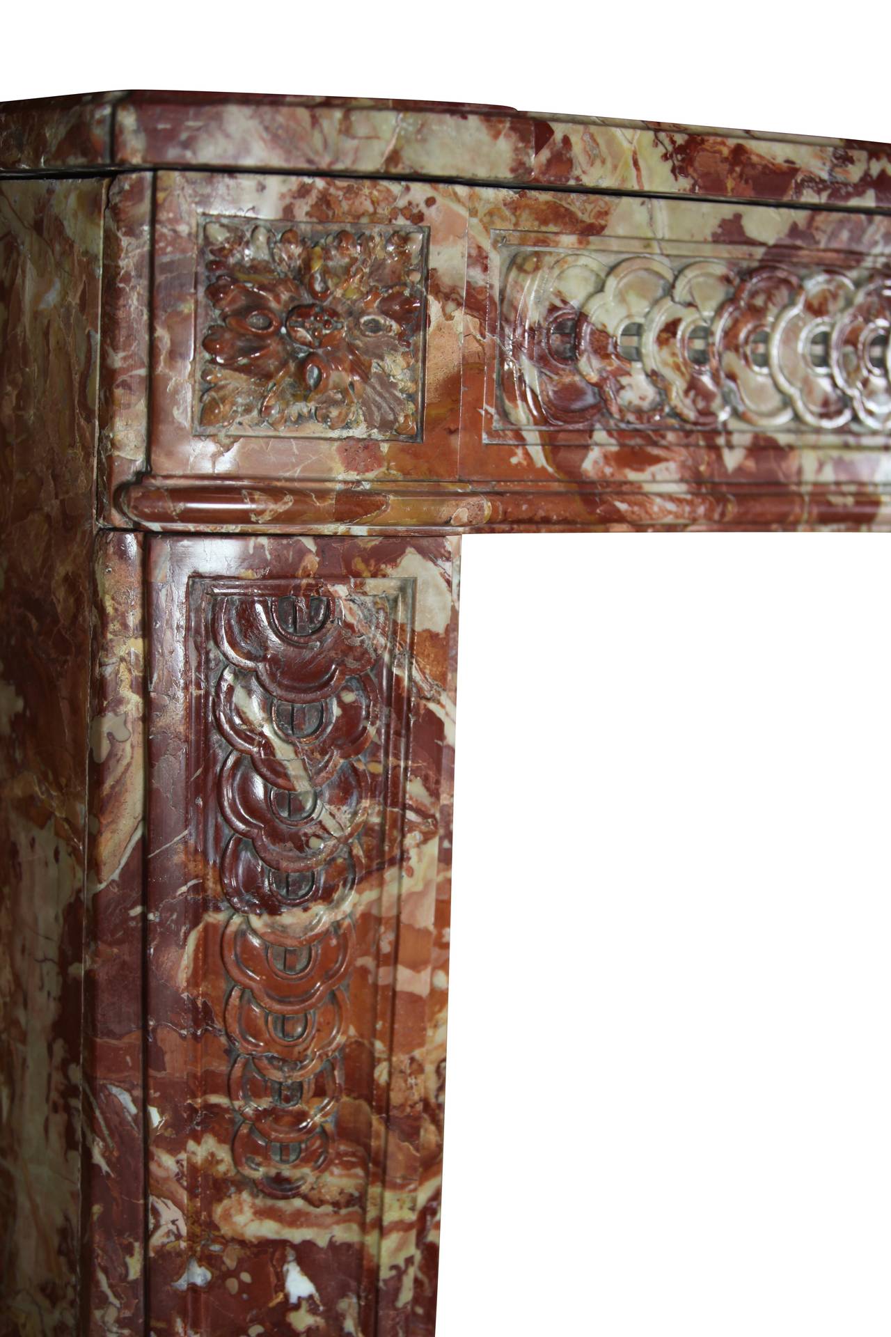 The deep color of the marble reflect the wealth and power of the original owner. This original antique fireplace surround is from the Louis XVI period. This is a very unique and commanding piece. A grand piece for a High end interior design.